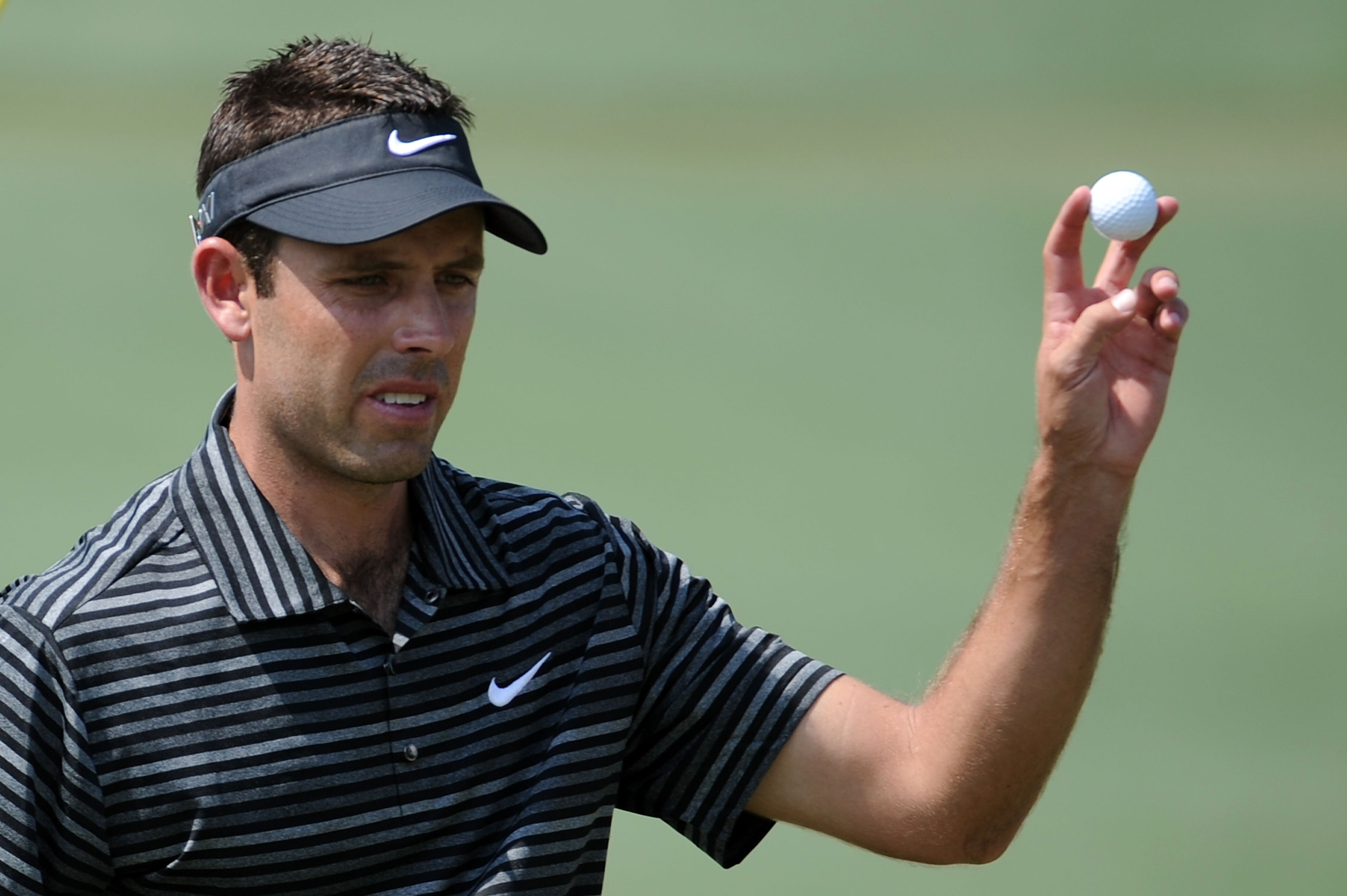 AUGUSTA, GA - APRIL 10:  Charl Schwartzel of South Africa waves to the gallery on the second green during the final round of the 2011 Masters Tournament on April 10, 2011 in Augusta, Georgia.  (Photo by Harry How/Getty Images)
