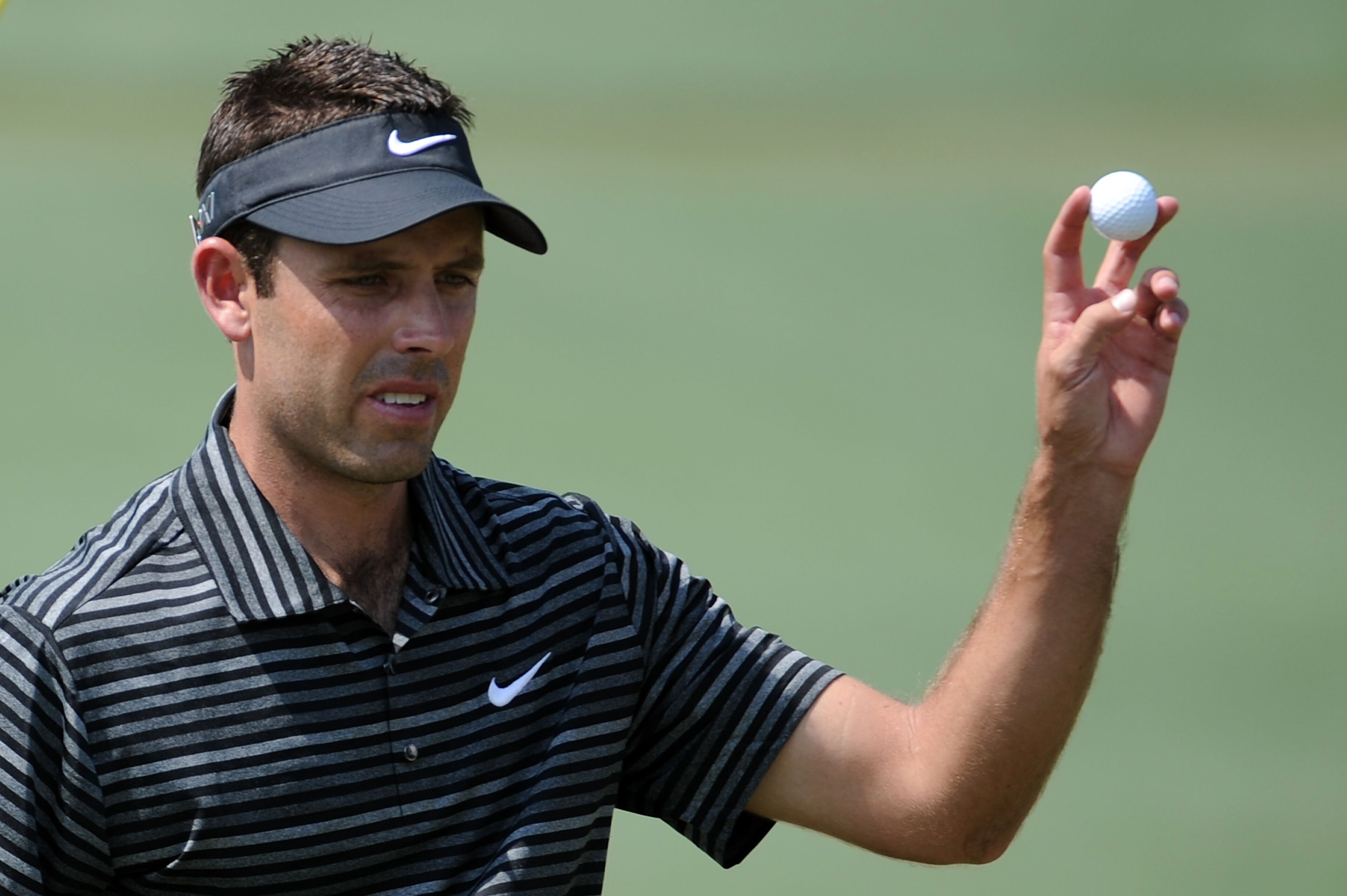 AUGUSTA, GA - APRIL 10:  Charl Schwartzel of South Africa waves to the gallery on the second green during the final round of the 2011 Masters Tournament on April 10, 2011 in Augusta, Georgia.  (Photo by Harry How/Getty Images)