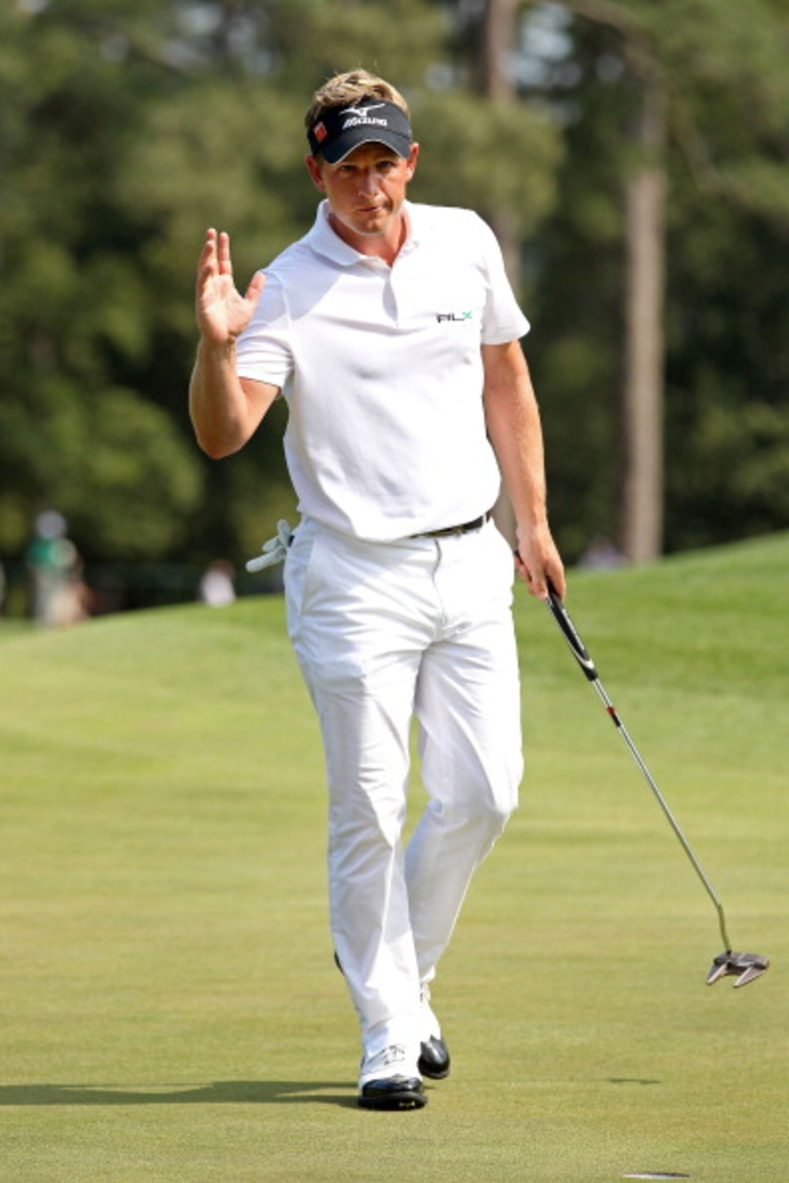 AUGUSTA, GA - APRIL 10:  Luke Donald of England waves to the gallery on the eighth green during the final round of the 2011 Masters Tournament at Augusta National Golf Club on April 10, 2011 in Augusta, Georgia.  (Photo by Andrew Redington/Getty Images)