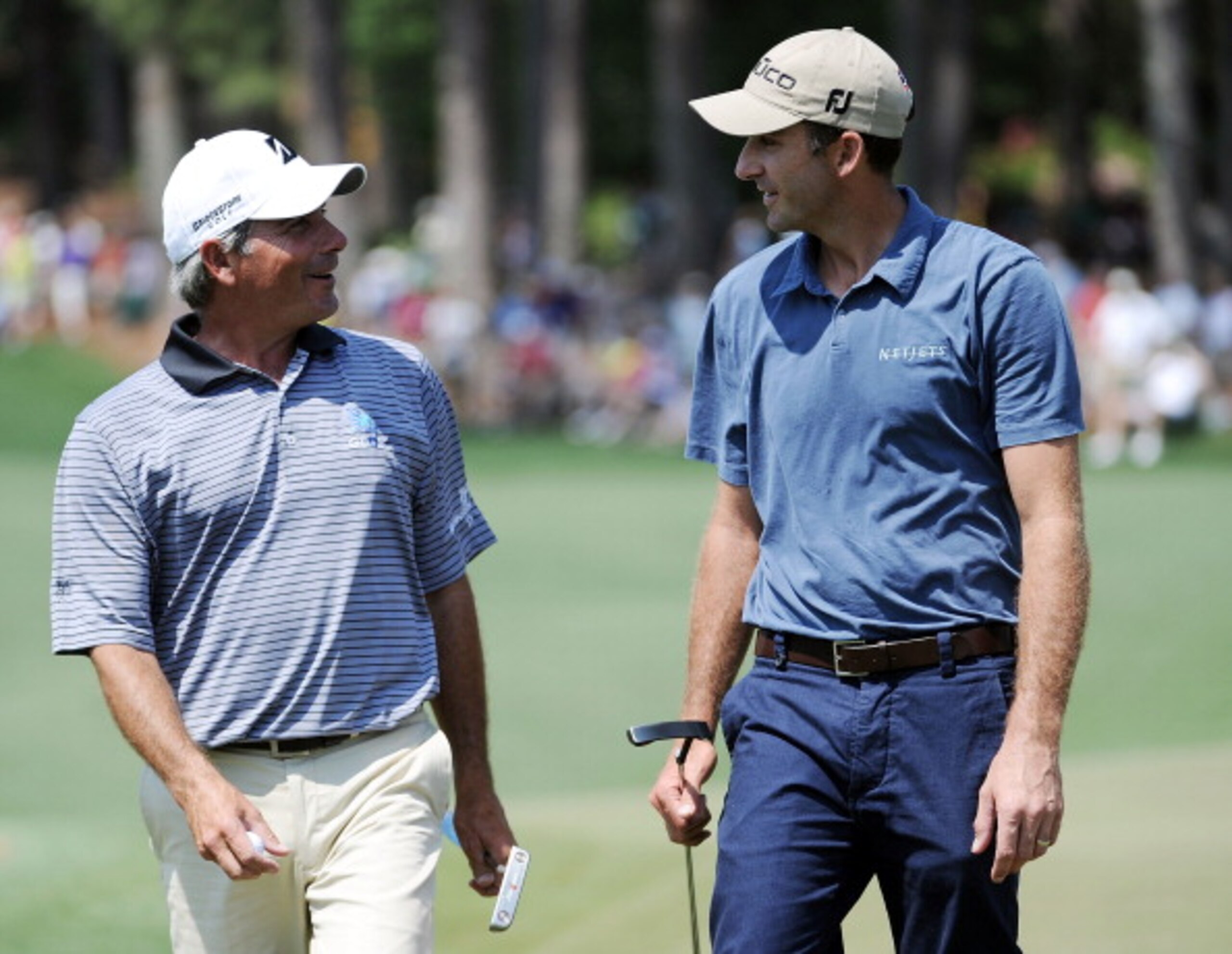 AUGUSTA, GA - APRIL 10:  Geoff Ogilvy of Australia (R) walks off the second green alongside Fred Couples  during the final round of the 2011 Masters Tournament at Augusta National Golf Club on April 10, 2011 in Augusta, Georgia.  (Photo by Harry How/Getty