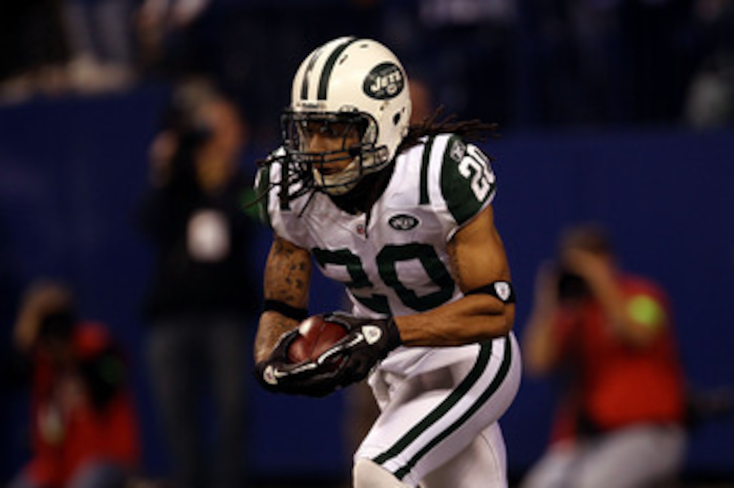 INDIANAPOLIS, IN - JANUARY 08:  Kyle Wilson #20 of the New York Jets returns a kickoff against the Indianapolis Colts during their 2011 AFC wild card playoff game at Lucas Oil Stadium on January 8, 2011 in Indianapolis, Indiana. The Jets won 17-16.  (Phot