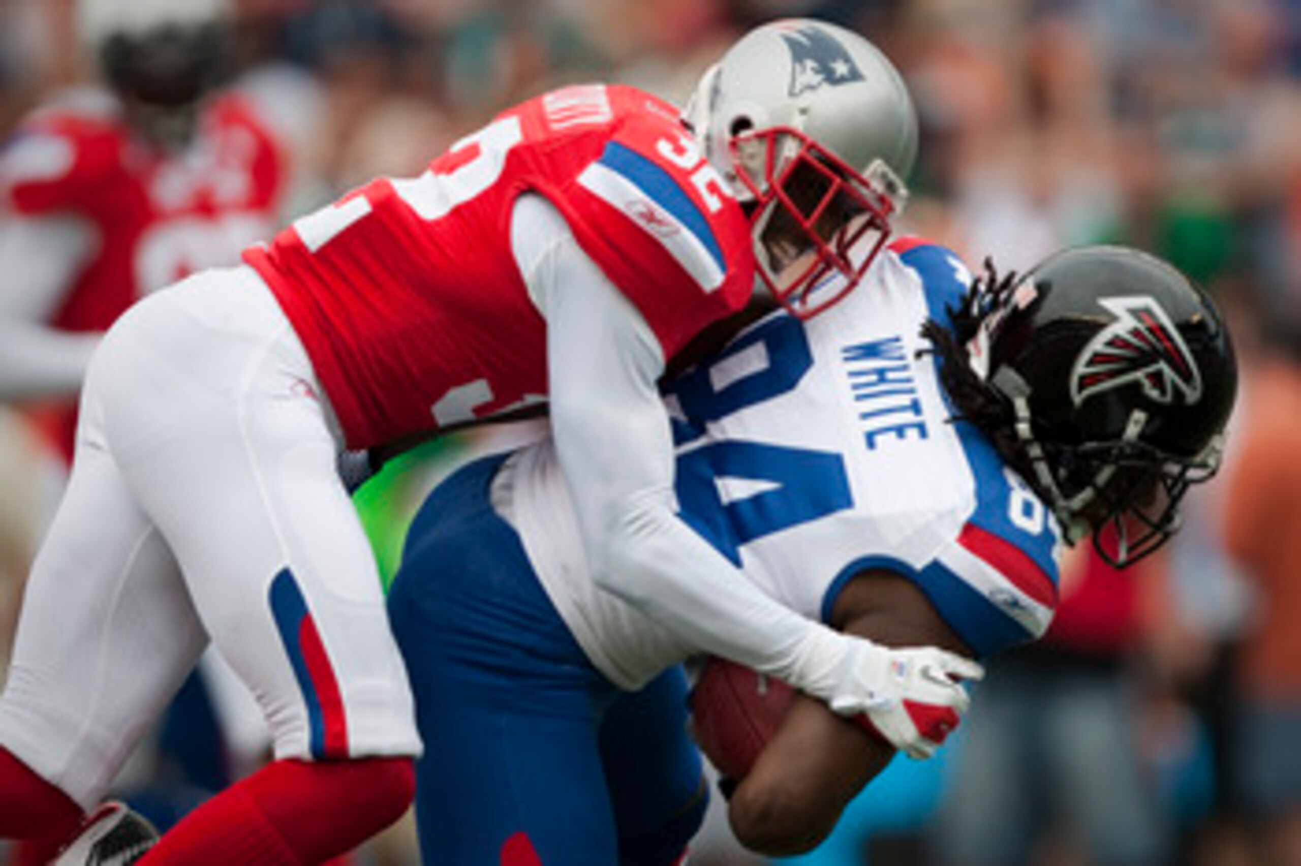 HONOLULU - JANUARY 30:  Devin McCourty, #32 of the New England Patriots, tackles Roddy White, #84 of the Atlanta Falcons, during the 2011 NFL Pro Bowl at Aloha Stadium on January 30, 2011 in Honolulu, Hawaii.  (Photo by Kent Nishimura/Getty Images)