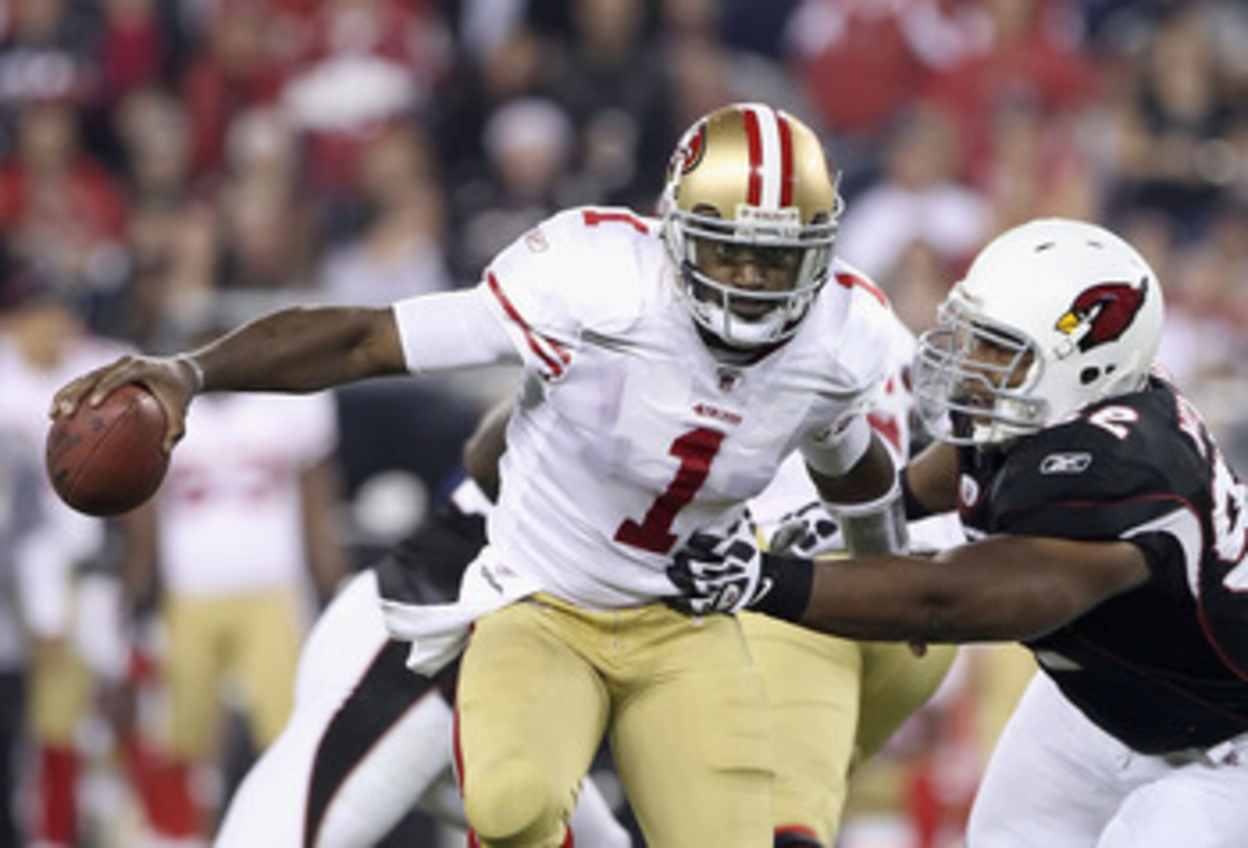 GLENDALE, AZ - NOVEMBER 29:  Quarterback Troy Smith #1 of the San Francisco 49ers scrambles with the football under pressure from Dan Williams #92 of the Arizona Cardinals during the first quarter of the NFL game at the University of Phoenix Stadium on No