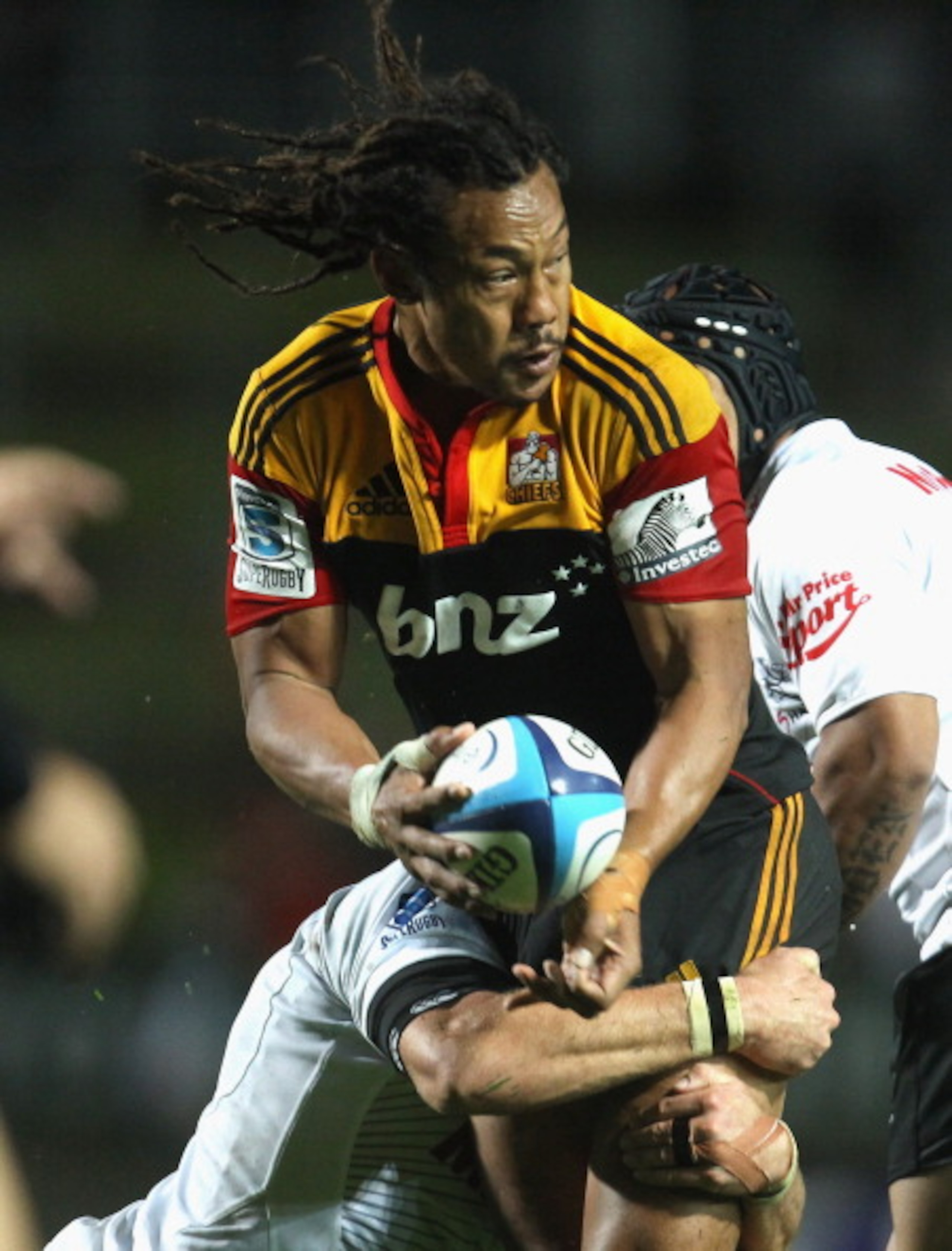 HAMILTON, NEW ZEALAND - MARCH 18:  Tana Umaga of the Chiefs is tackled during the round five Super Rugby match between the Chiefs and the Sharks at Waikato Stadium on March 18, 2011 in Hamilton, New Zealand.  (Photo by Phil Walter/Getty Images)