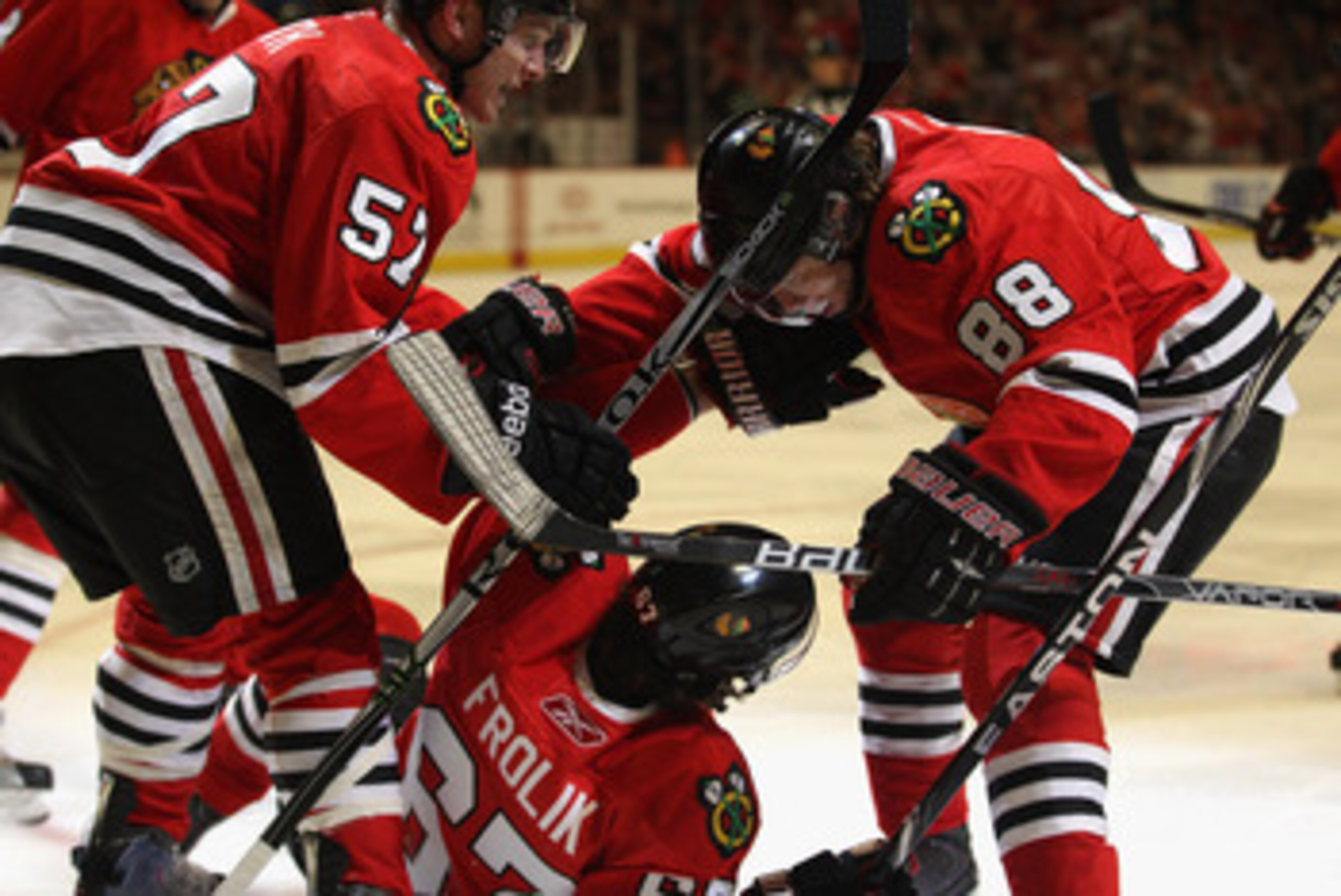 CHICAGO, IL - APRIL 10: Michael Frolik #67 of the Chicago Blackhawks is congratulated by teammates Ben Smith #57 and Patrick Kane #88 after scoring a goal in the 2nd period against the Detroit Red Wings at the United Center on April 10, 2011 in Chicago, I CHICAGO, IL - APRIL 10: Michael Frolik #67 of the Chicago Blackhawks is congratulated by teammates Ben Smith #57 and Patrick Kane #88 after scoring a goal in the 2nd period against the Detroit Red Wings at the United Center on April 10, 2011 in Chicago, I