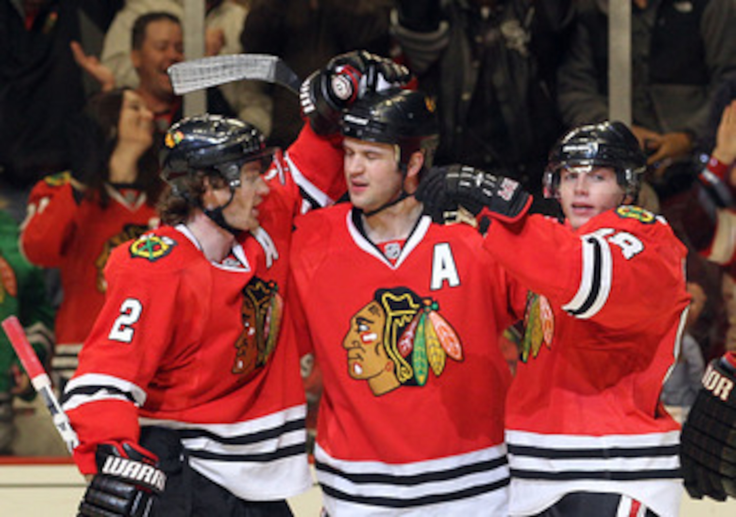 CHICAGO, IL - MARCH 23: Brent Seabrook #7 of the Chicago Blackhawks scores at 14:41 of the second period against the Florida Panthers and is joined by Duncan Keith #2 (L) and Patrick Kane #88 (R) at the United Center on March 23, 2011 in Chicago, Illinois
