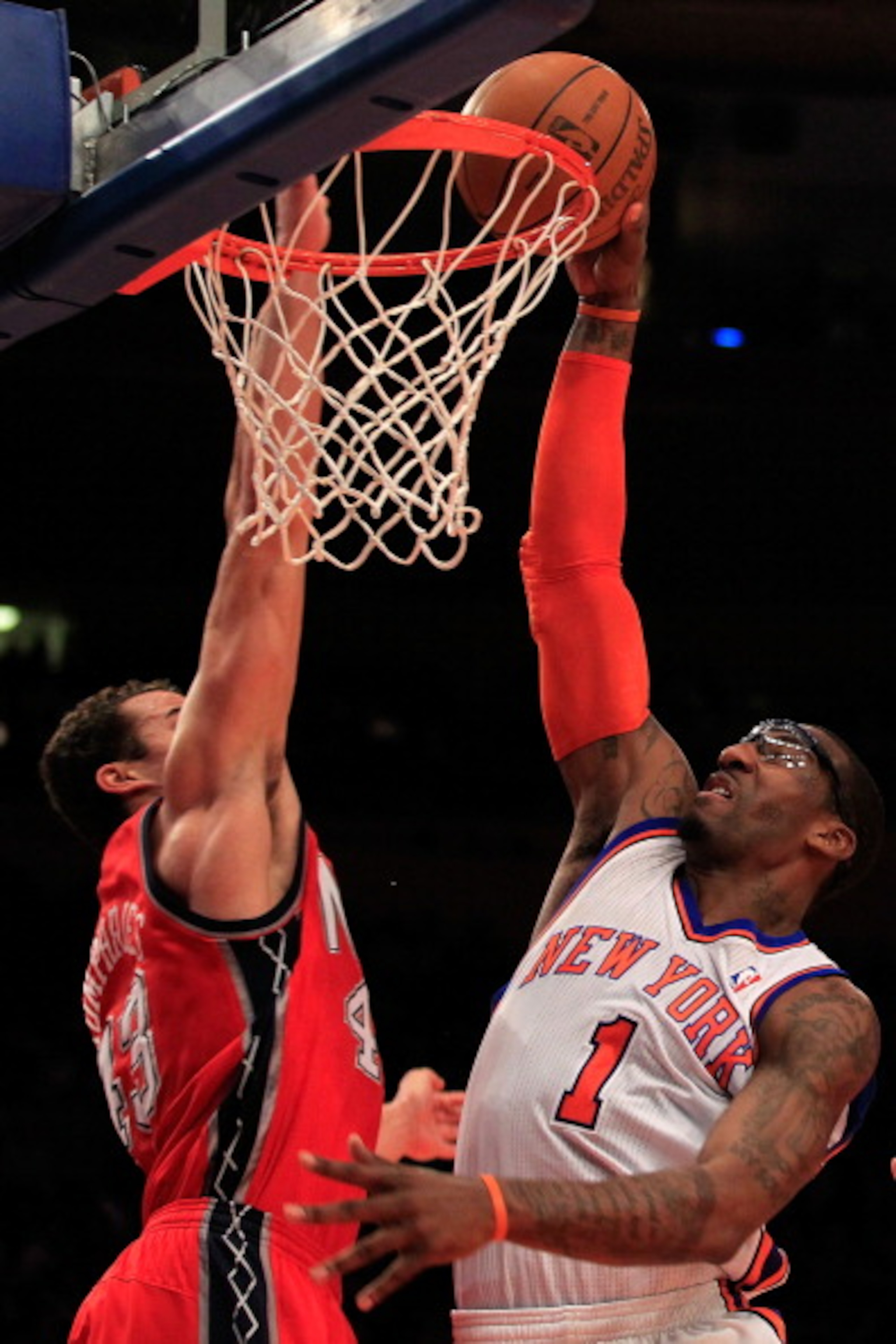NEW YORK, NY - MARCH 30:  Amar'e Stoudemire #1 of the New York Knicks shoots over Kris Humphries #43 of the New Jersey Nets at Madison Square Garden on March 30, 2011 in New York City. NOTE TO USER: User expressly acknowledges and agrees that, by download