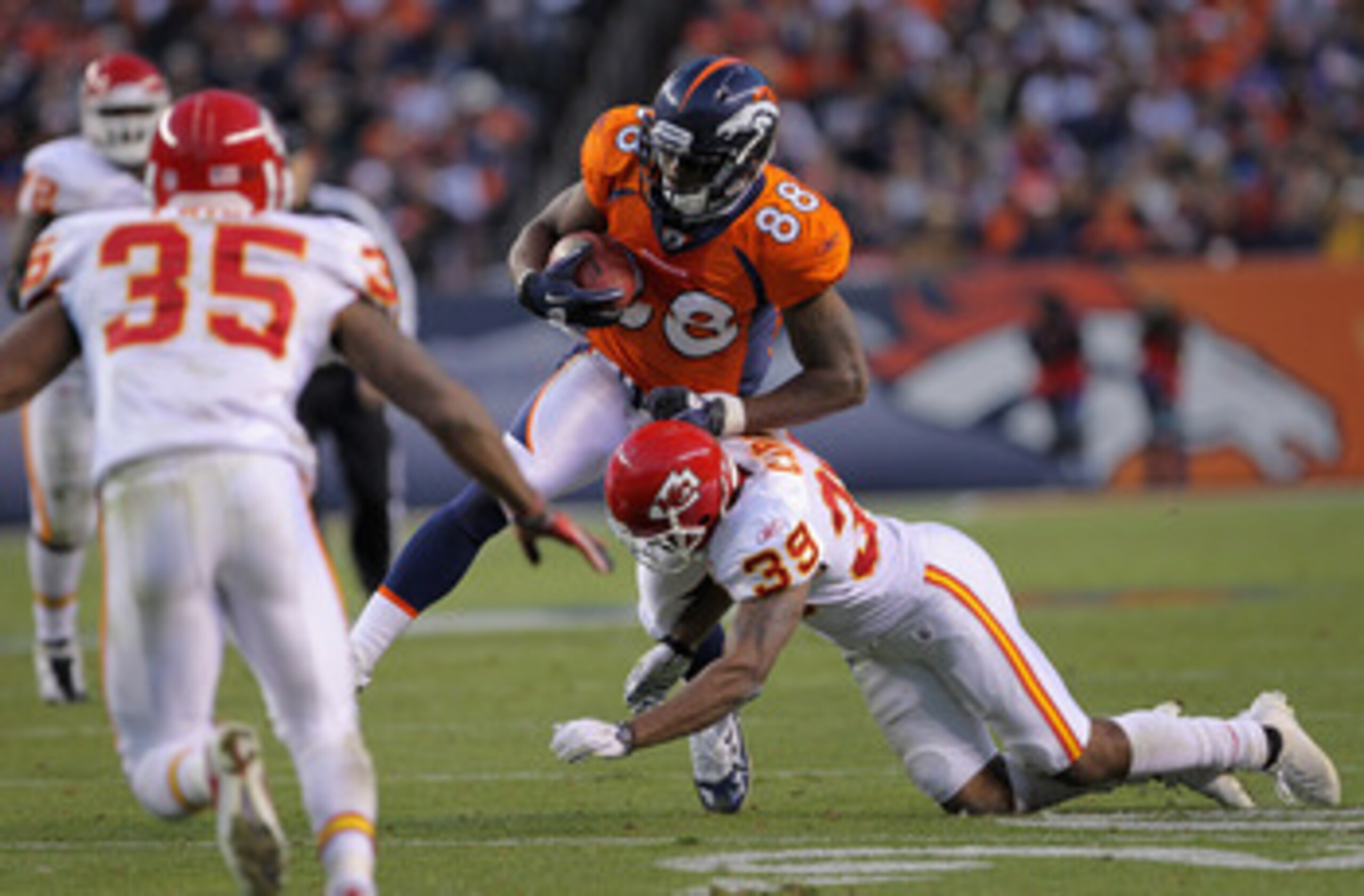 DENVER - NOVEMBER 14:  Wide receiver Demaryius Thomas #88 of the Denver Broncos makes a pass reception as Brandon Carr #39 of the Kansas City Chiefs makes the tackle at INVESCO Field at Mile High on November 14, 2010 in Denver, Colorado. The Broncos defea