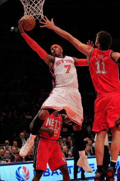 NEW YORK, NY - MARCH 30: Carmelo Anthony #7 of the New York Knicks shoots over Brook Lopez #11 of the New Jersey Nets at Madison Square Garden on March 30, 2011 in New York City. NOTE TO USER: User expressly acknowledges and agrees that, by downloading an