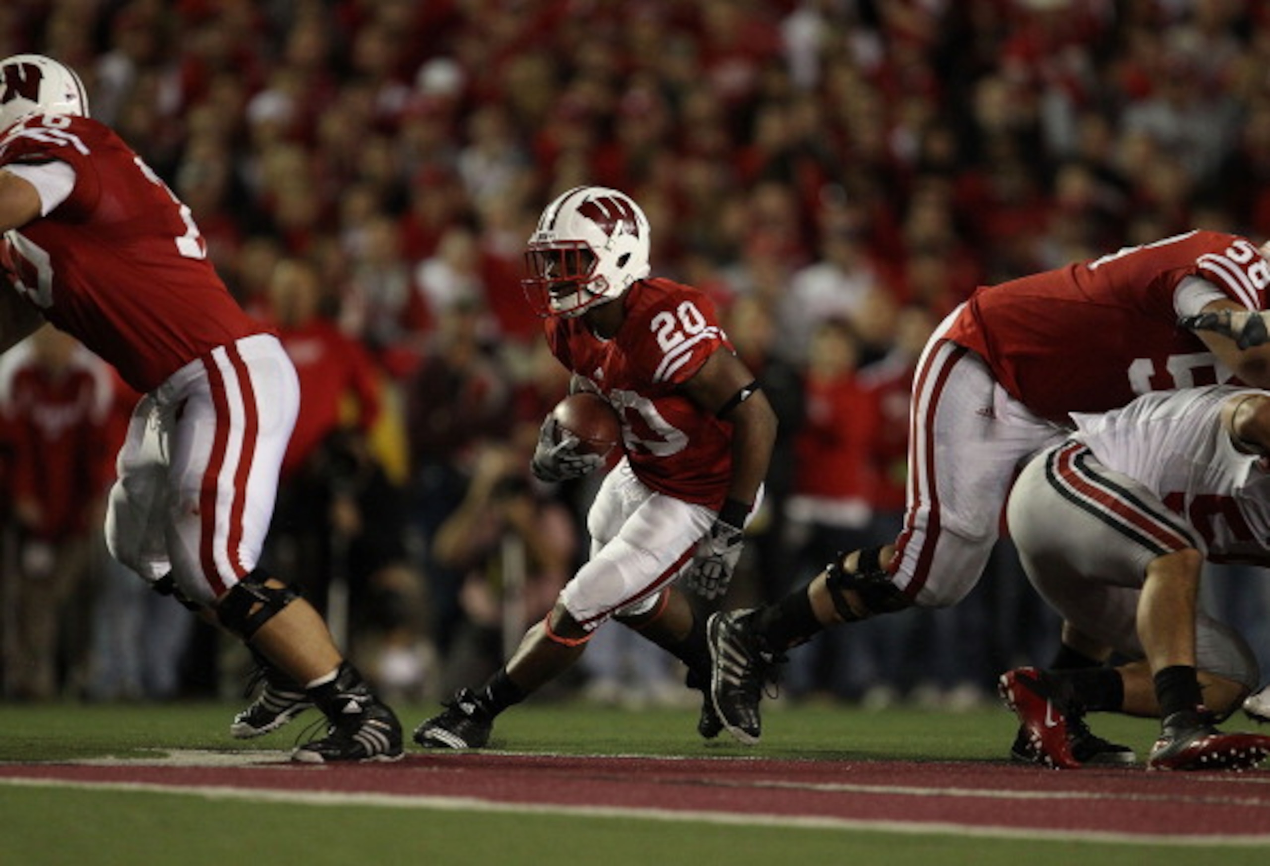 MADISON, WI - OCTOBER 16: James White #20 of the Wisconsin Badgers runs against the Ohio State Buckeyes at Camp Randall Stadium on October 16, 2010 in Madison, Wisconsin. Wisconsin defeated Ohio State 31-18. (Photo by Jonathan Daniel/Getty Images) MADISON, WI - OCTOBER 16: James White #20 of the Wisconsin Badgers runs against the Ohio State Buckeyes at Camp Randall Stadium on October 16, 2010 in Madison, Wisconsin. Wisconsin defeated Ohio State 31-18. (Photo by Jonathan Daniel/Getty Images)