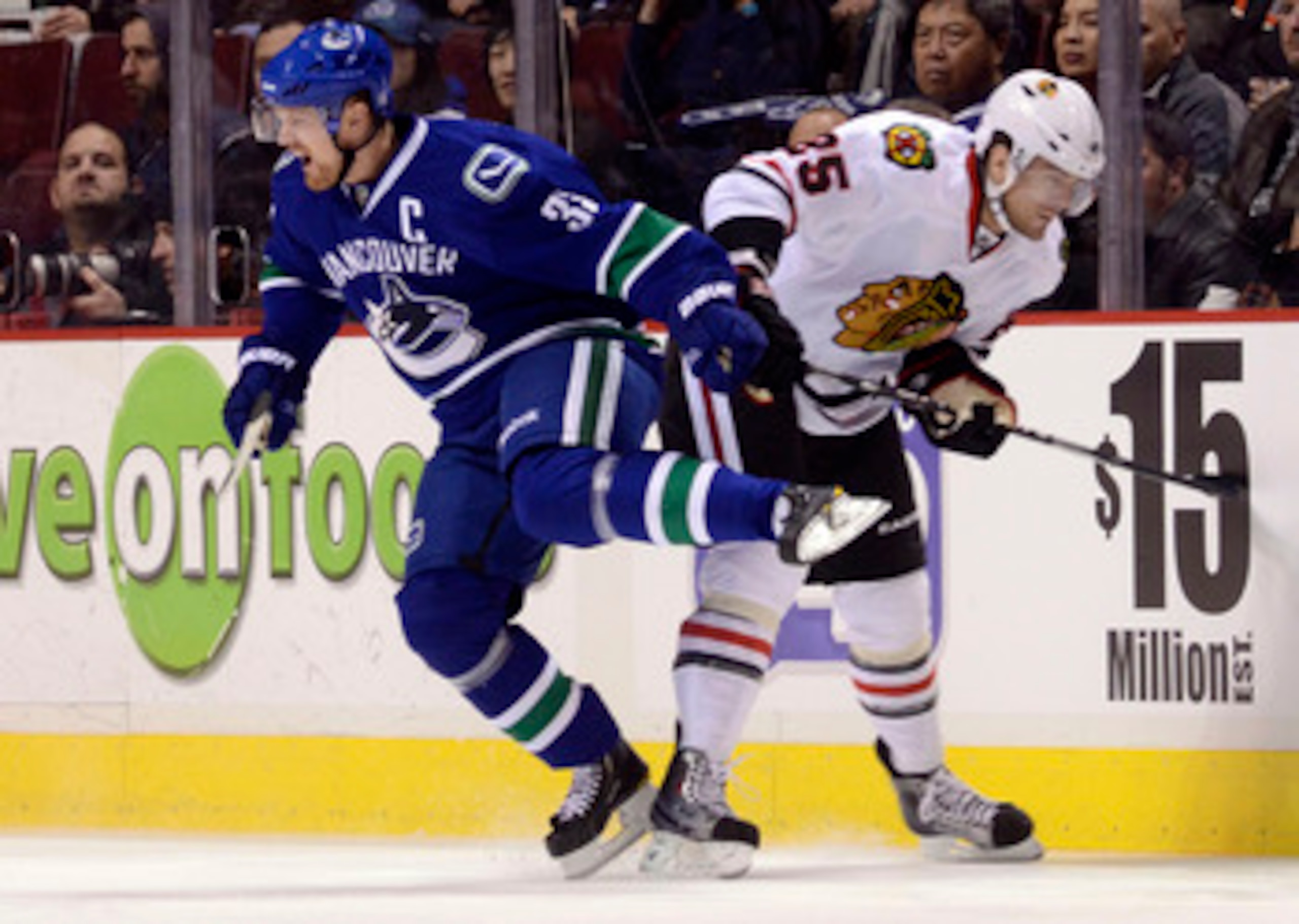 VANCOUVER, CANADA - FEBRUARY 4: Henrik Sedin #33 of the Vancouver Canucks reacts after colliding with Viktor Stalberg #25 of the Chicago Blackhawks during the first period in NHL action on February 04, 2011 at Rogers Arena in Vancouver, British Columbia,