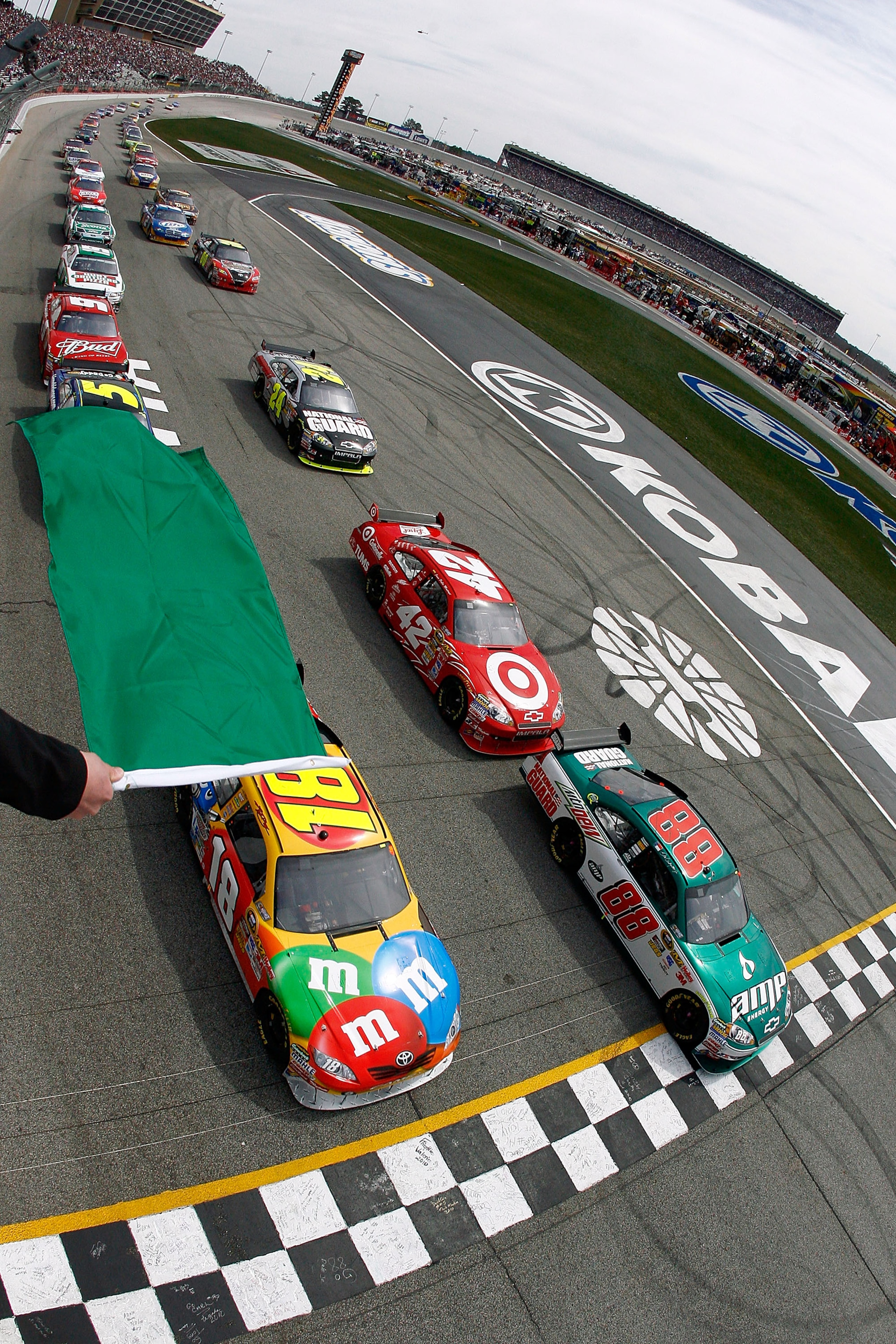 ATLANTA - MARCH 07: Dale Earnhardt Jr., driver of the #88 AMP Energy/National Guard Chevrolet, and Kyle Busch, driver of the #18 M&M's Toyota, leads the field to the green flag to start the NASCAR Sprint Cup Series Kobalt Tools 500 at Atlanta Motor Speed ATLANTA - MARCH 07: Dale Earnhardt Jr., driver of the #88 AMP Energy/National Guard Chevrolet, and Kyle Busch, driver of the #18 M&M's Toyota, leads the field to the green flag to start the NASCAR Sprint Cup Series Kobalt Tools 500 at Atlanta Motor Speed