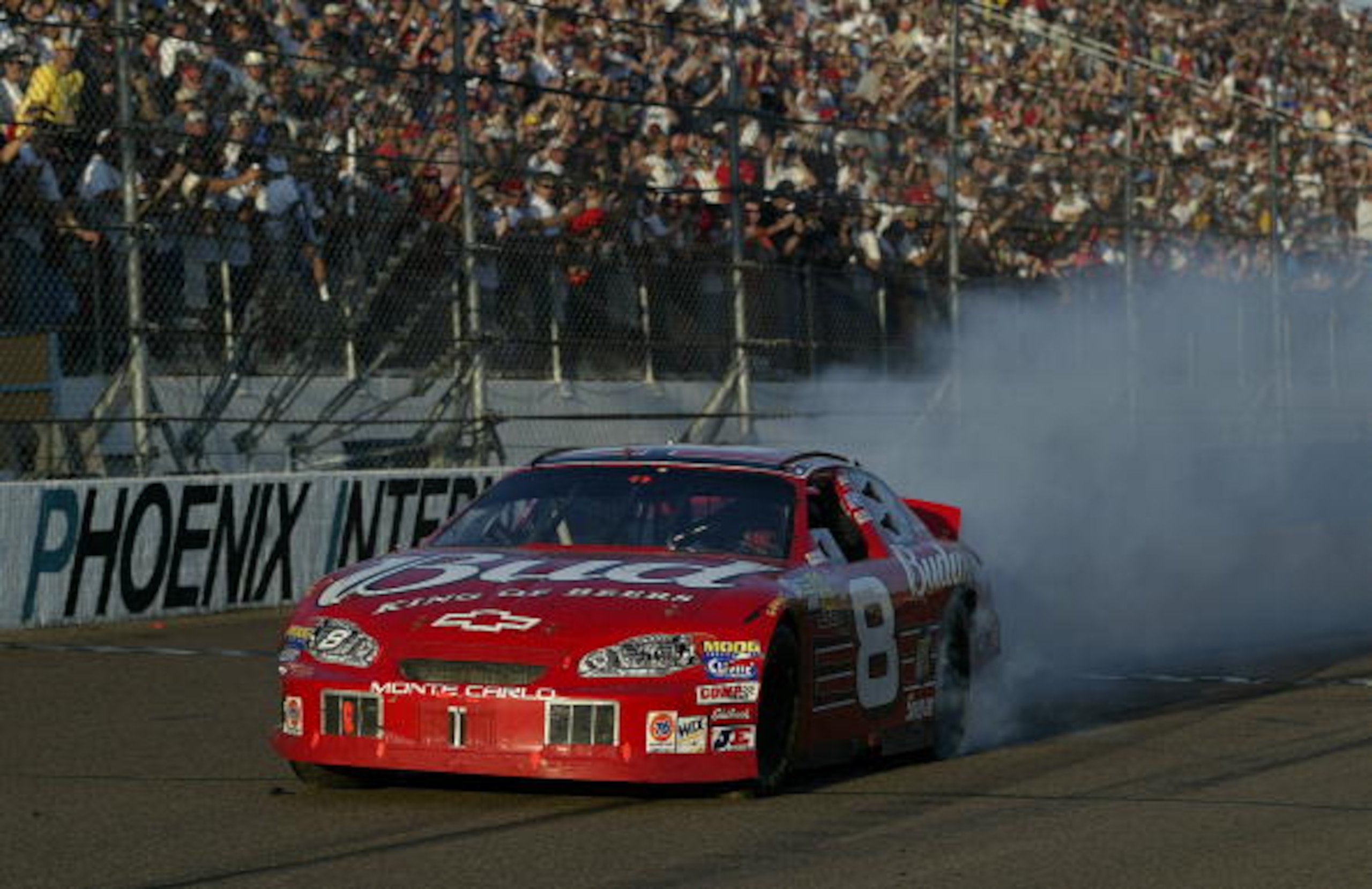 PHOENIX, AZ- NOVEMBER 2: Dale Earnhardt Jr. celebrates his victory in his #8 Budweiser Chevrloet during the NASCAR Winston Cup Checker Auto Parts 500 on November 2, 2003 at Phoenix International Raceway in Phoenix, Arizona. (Photo by Jon Ferrey/Getty Ima PHOENIX, AZ- NOVEMBER 2: Dale Earnhardt Jr. celebrates his victory in his #8 Budweiser Chevrloet during the NASCAR Winston Cup Checker Auto Parts 500 on November 2, 2003 at Phoenix International Raceway in Phoenix, Arizona. (Photo by Jon Ferrey/Getty Ima
