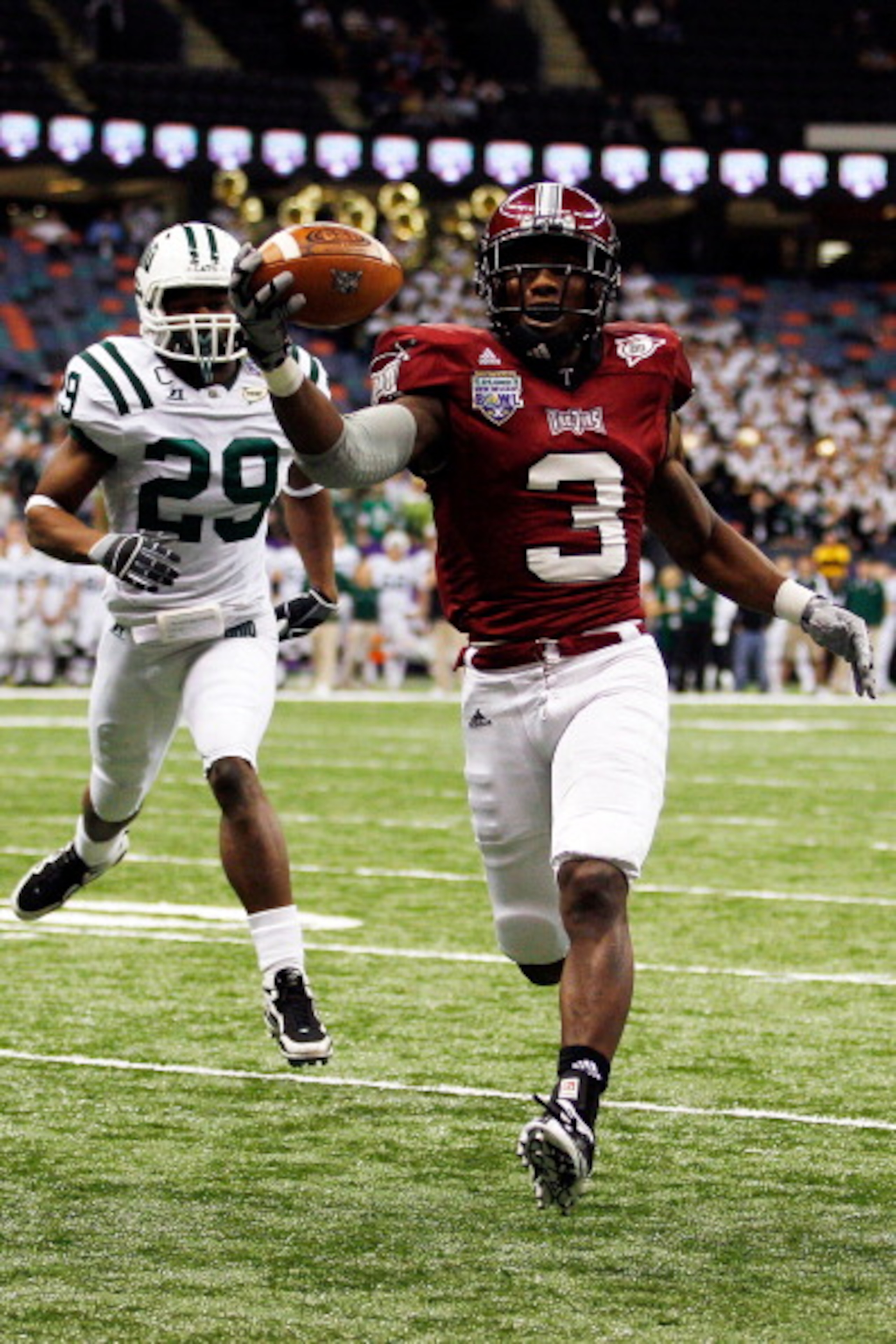 NEW ORLEANS, LA - DECEMBER 18:  Jerrel Jernigan #3 of the Troy University Trojans scores a touchdown over Donovan Fletcher #29 of the Ohio University Bobcats during the R&L Carriers New Orleans Bowl at the Louisiana Superdome on December 18, 2010 in New O