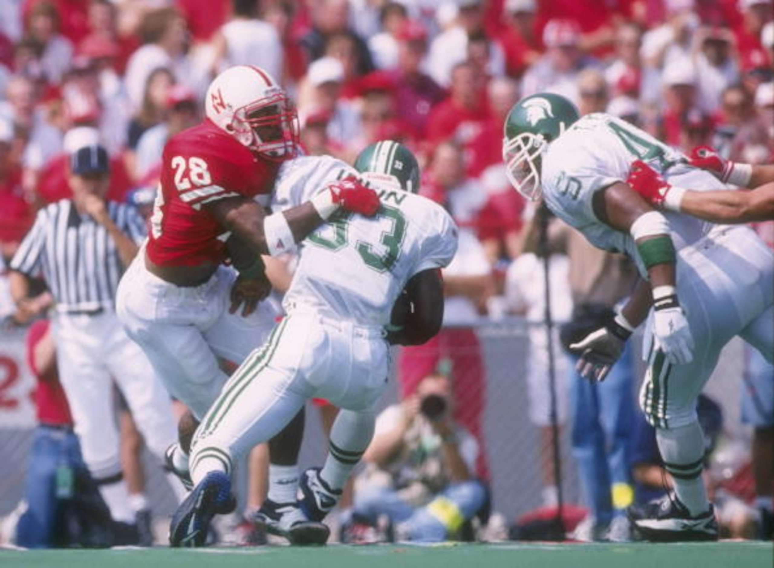7 Sep 1996: Linebacker Jamel Williams of the Nebraska Cornhuskers tackles running back Sedrick Irvin of the Michigan State Spartans during a game at Memorial Stadium in Lincoln, Nebraska. Nebraska won the game, 55-14. Mandatory Credit: Stephen Dunn /Al 7 Sep 1996: Linebacker Jamel Williams of the Nebraska Cornhuskers tackles running back Sedrick Irvin of the Michigan State Spartans during a game at Memorial Stadium in Lincoln, Nebraska. Nebraska won the game, 55-14. Mandatory Credit: Stephen Dunn /Al