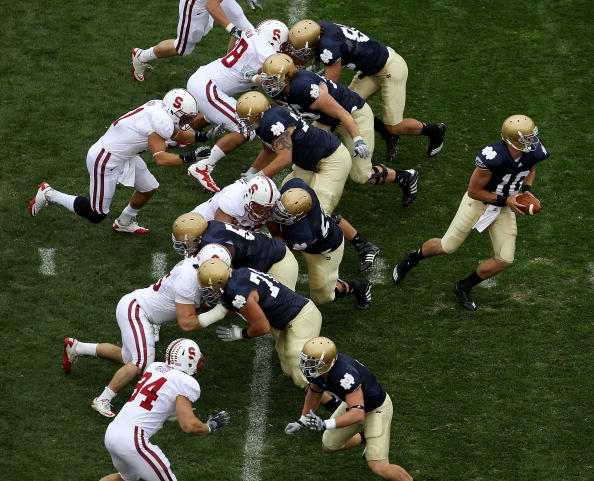 SOUTH BEND, IN - SEPTEMBER 25: Dayne Crist #10 of the Notre Dame Fighting Irish turns to hand-off as his offensive line blocks against the Stanford Cardinal defense at Notre Dame Stadium on September 25, 2010 in South Bend, Indiana. Standford defeated Not