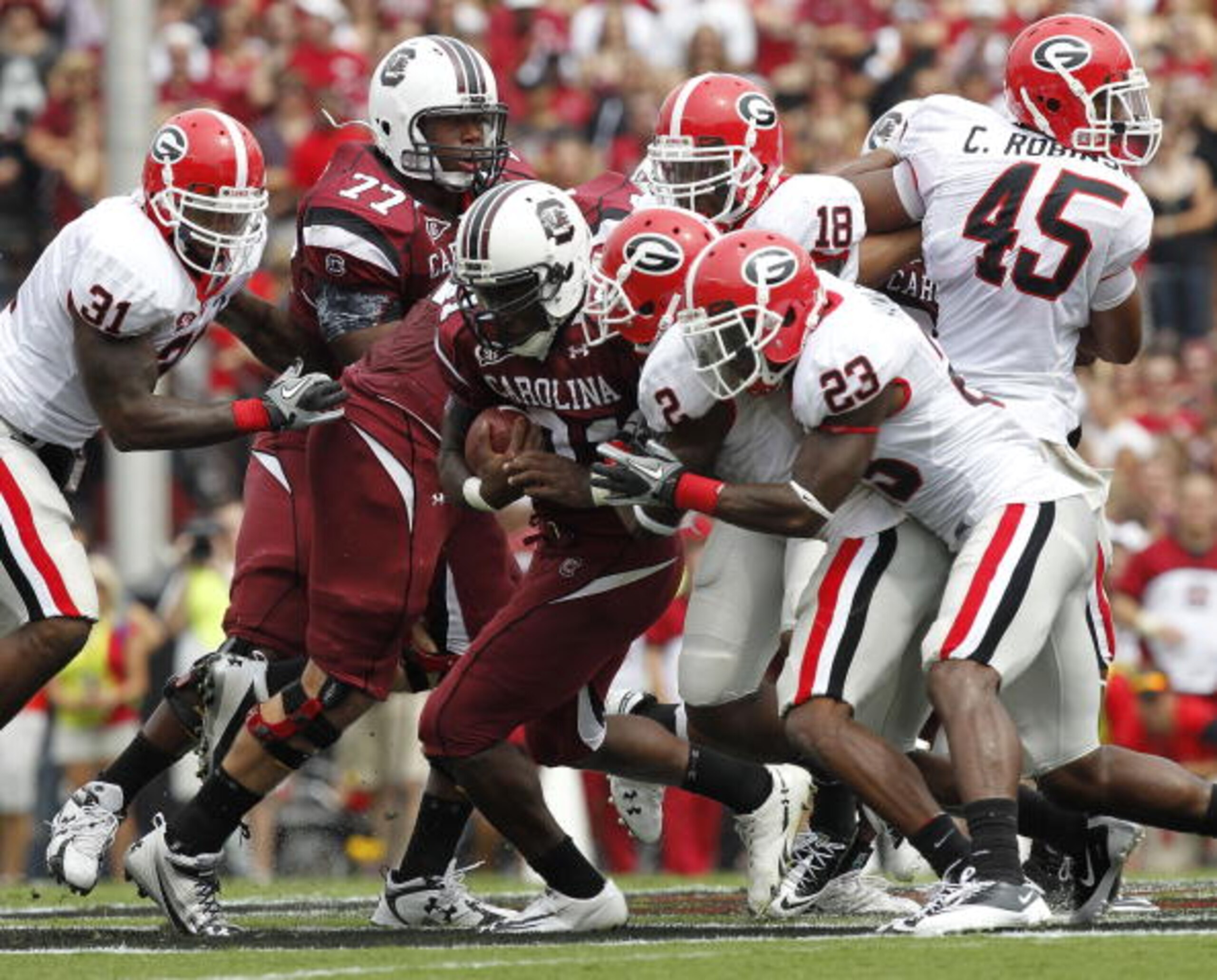 COLUMBIA, SC - SEPTEMBER 11: Tailback Marcus Lattimore #21 of the South Carolina Gamecocks (center with ball) is tackled by cornerback Brandon Boykin #2 and free safety Jakar Hamilton #23 of the Georgia Bulldogs during the game at Williams-Brice Stadium o COLUMBIA, SC - SEPTEMBER 11: Tailback Marcus Lattimore #21 of the South Carolina Gamecocks (center with ball) is tackled by cornerback Brandon Boykin #2 and free safety Jakar Hamilton #23 of the Georgia Bulldogs during the game at Williams-Brice Stadium o