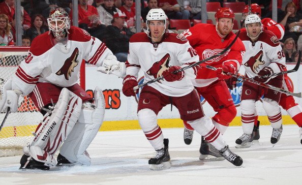 DETROIT,MI - NOVEMBER 8:  IIya Bryzgalov #30 and Sami Lepisto #18 of the Phoenix Coyotes defend against Johan Franzen #93 of the Detroit Red Wings in a game on November 8,2010 at the Joe Louis Arena in Detroit, Michigan. The Wings defeated the Coyotes 3-2