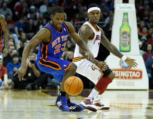 CLEVELAND - FEBRUARY 25:  Toney Douglas #23 of the New York Knicks and Daniel Gibson #1 of the Cleveland Cavaliers fight for a loose ball during the game on February 25, 2011 at Quicken Loans Arena in Cleveland, Ohio. NOTE TO USER: User expressly acknowle