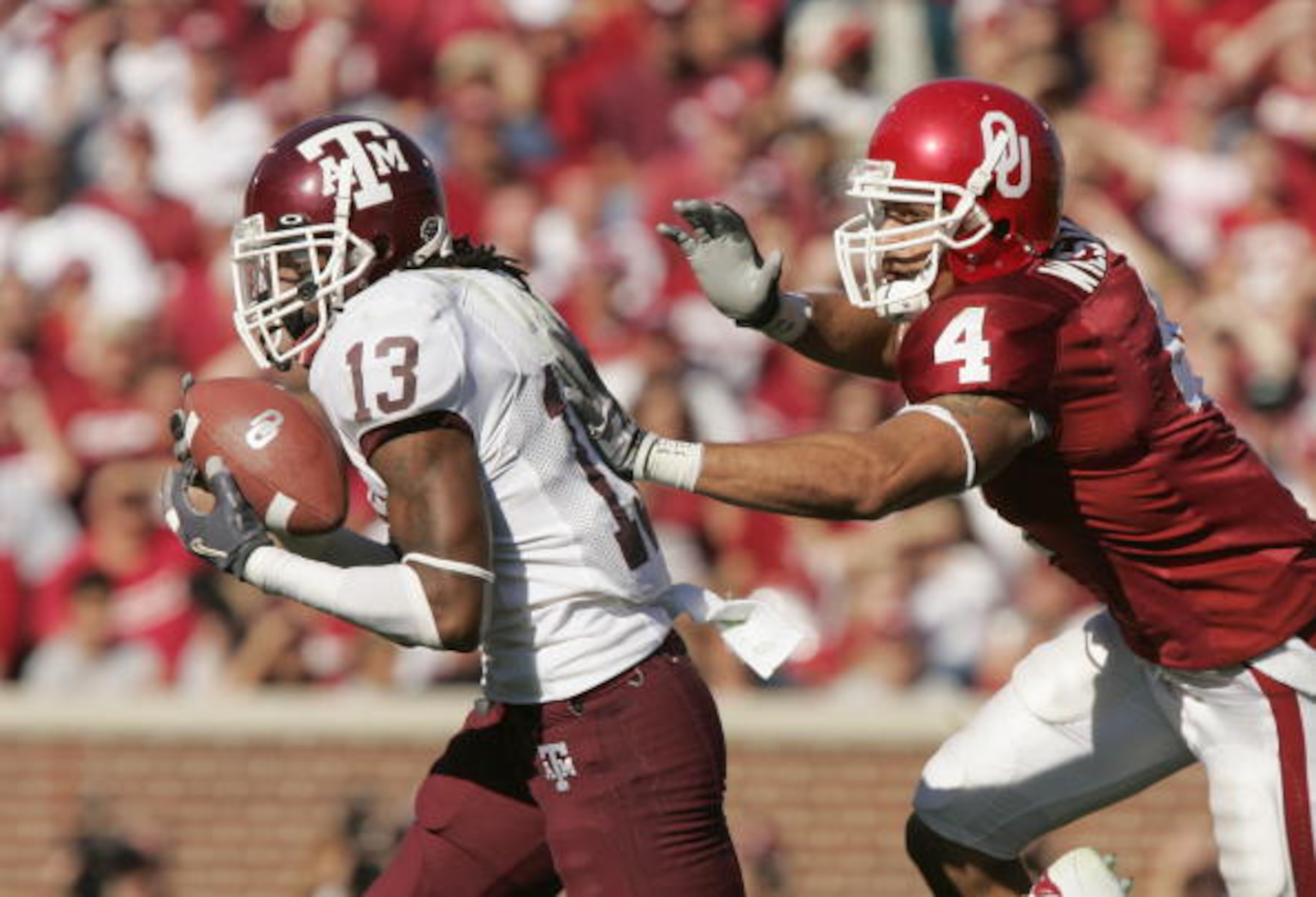 NORMAN, OK - NOVEMBER 12: Travis Wilson #4 of the Oklahoma Sooners moves to tackle Marquis Carpenter #13 of the Texas A&M Aggies during the game on November 12, 2005 at Memorial Stadium in Norman, Oklahoma. The Sooners won 36-30. (Photo by Brian Bahr/G NORMAN, OK - NOVEMBER 12: Travis Wilson #4 of the Oklahoma Sooners moves to tackle Marquis Carpenter #13 of the Texas A&M Aggies during the game on November 12, 2005 at Memorial Stadium in Norman, Oklahoma. The Sooners won 36-30. (Photo by Brian Bahr/G