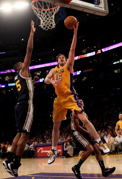 LOS ANGELES, CA - APRIL 5:  Pau Gasol #16 of the Los Angeles Lakers shoots over Derrick Favors #15 of the Utah Jazz at Staples Center on April 5, 2011 in Los Angeles, California. The Jazz won 86-85.  NOTE TO USER: User expressly acknowledges and agrees th