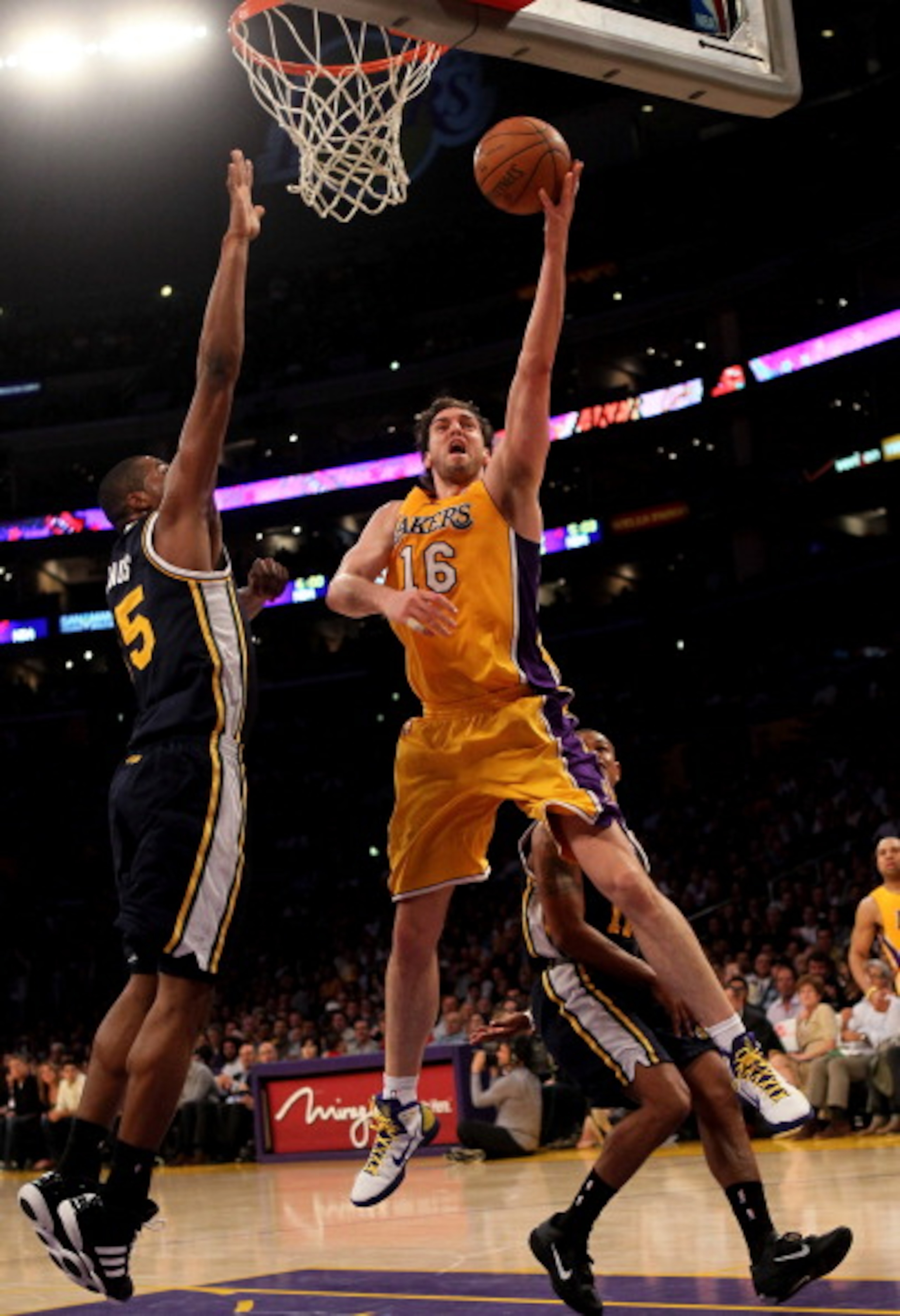 LOS ANGELES, CA - APRIL 5:  Pau Gasol #16 of the Los Angeles Lakers shoots over Derrick Favors #15 of the Utah Jazz at Staples Center on April 5, 2011 in Los Angeles, California. The Jazz won 86-85.  NOTE TO USER: User expressly acknowledges and agrees th