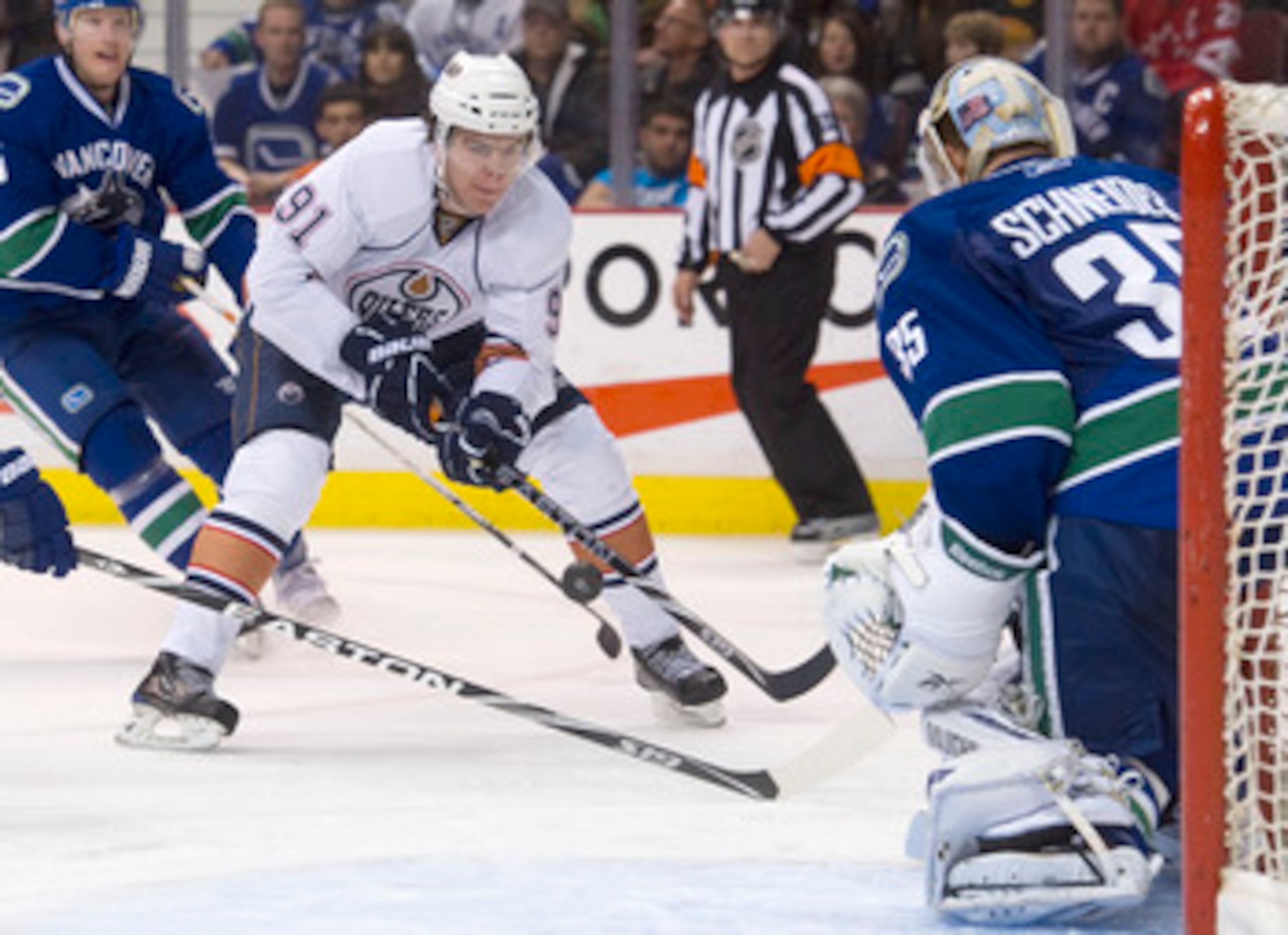 VANCOUVER, CANADA - DECEMBER 26: Magnus Paajarvi #91 of the Edmonton Oilers fires a shot on goalie Cory Schneider #35 of the Vancouver Canucks during the third period in NHL action on December 26, 2010 at Rogers Arena in Vancouver, BC, Canada.  (Photo by