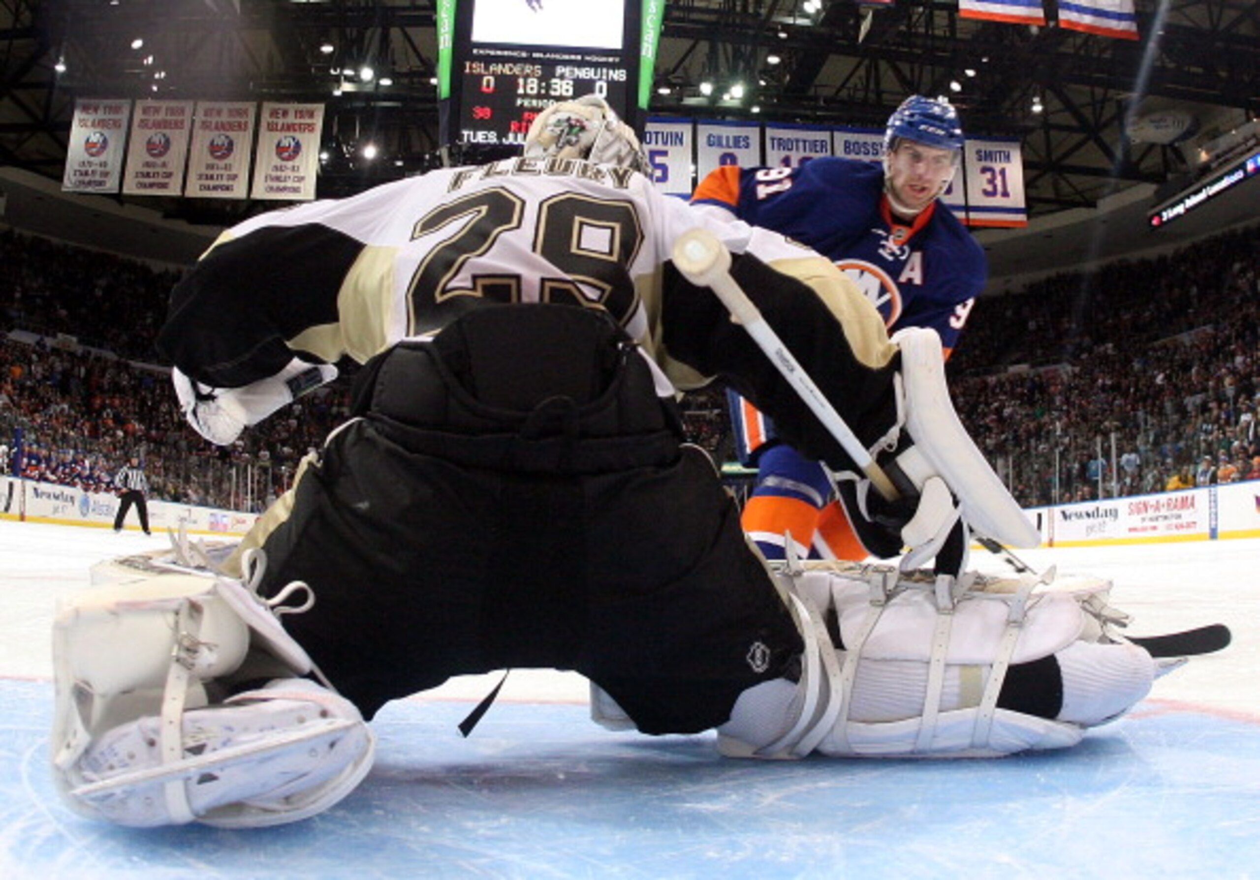 UNIONDALE, NY - APRIL 08:  Marc-Andre Fleury #29 of the Pittsburgh Penguins stops John Tavares #91 of the New York Islanders during the shootout at the Nassau Coliseum on April 8, 2011 in Uniondale, New York. The Penguins defeated the Islanders 4-3 in the