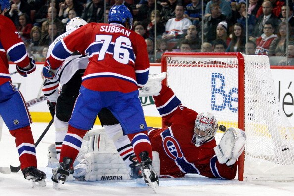 MONTREAL, CANADA - APRIL 5:  Carey Price #31 of the Montreal Canadiens makes a glove save on the puck in front of Marian Hossa #81 of the Chicago Blackhawks during the NHL game at the Bell Centre on April 5, 2011 in Montreal, Quebec, Canada.  The Canadien