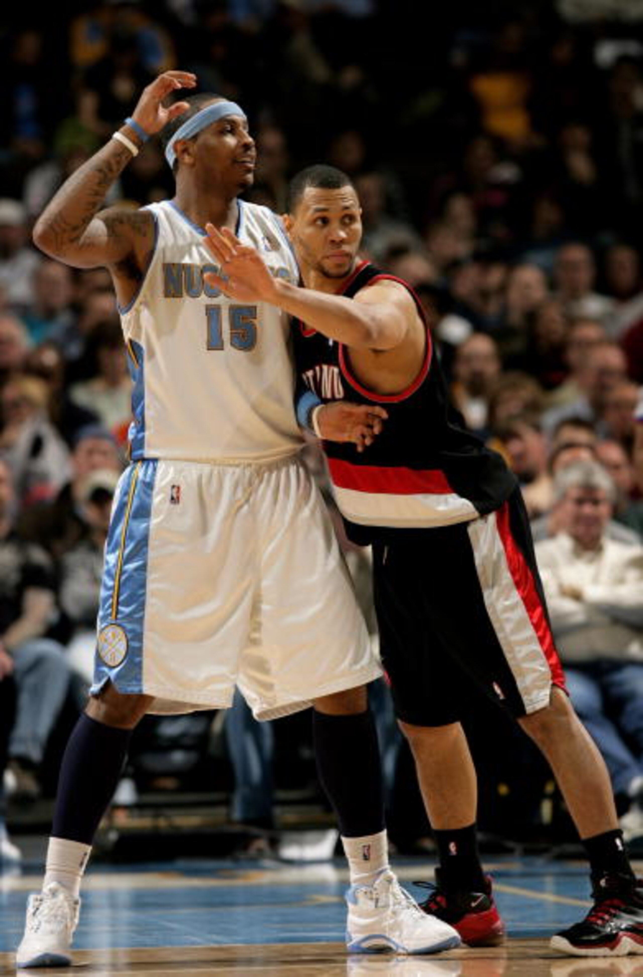 DENVER - MARCH 05:  Carmelo Anthony #15 of the Denver Nuggets looks for the ball as Brandon Roy #7 of the Portland Trail Blazers defends during NBA action at the Pepsi Center on March 5, 2009 in Denver, Colorado. The Nuggets defeated the Trail Blazers 106