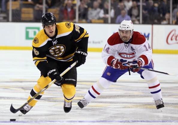 BOSTON, MA - MARCH 24:  Nathan Horton #18 of the Boston Bruins takes the puck as Tomas Plekanec #14 of the Montreal Canadiens defends on March 24, 2011 at the TD Garden in Boston, Massachusetts.  (Photo by Elsa/Getty Images)