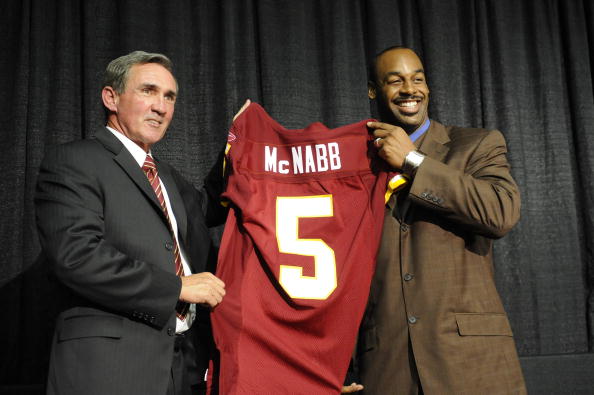 ASHURN, VA - APRIL 6:  Mike Shanahan, head coach of the Washington Redskins presents Donovan McNabb with his new jersey during a press conference on April 6, 2010 at Redskin Park in Ashburn, Virginia.  (Photo by Mitchell Layton/Getty Images)