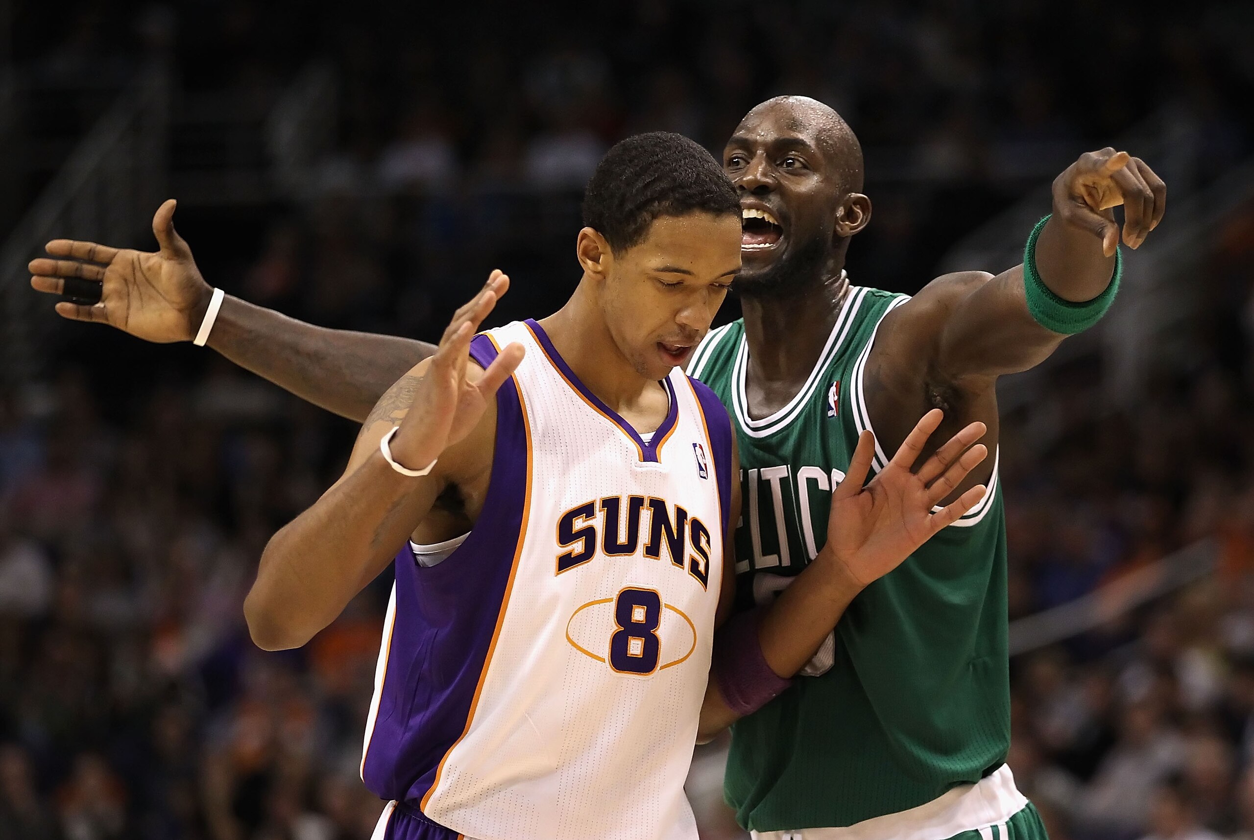 PHOENIX, AZ - JANUARY 28:  Kevin Garnett #5 of the Boston Celtics reacts to Channing Frye #8 of the Phoenix Suns during the NBA game at US Airways Center on January 28, 2011 in Phoenix, Arizona.  The Suns defeated the Celtics 88-71. NOTE TO USER: User exp