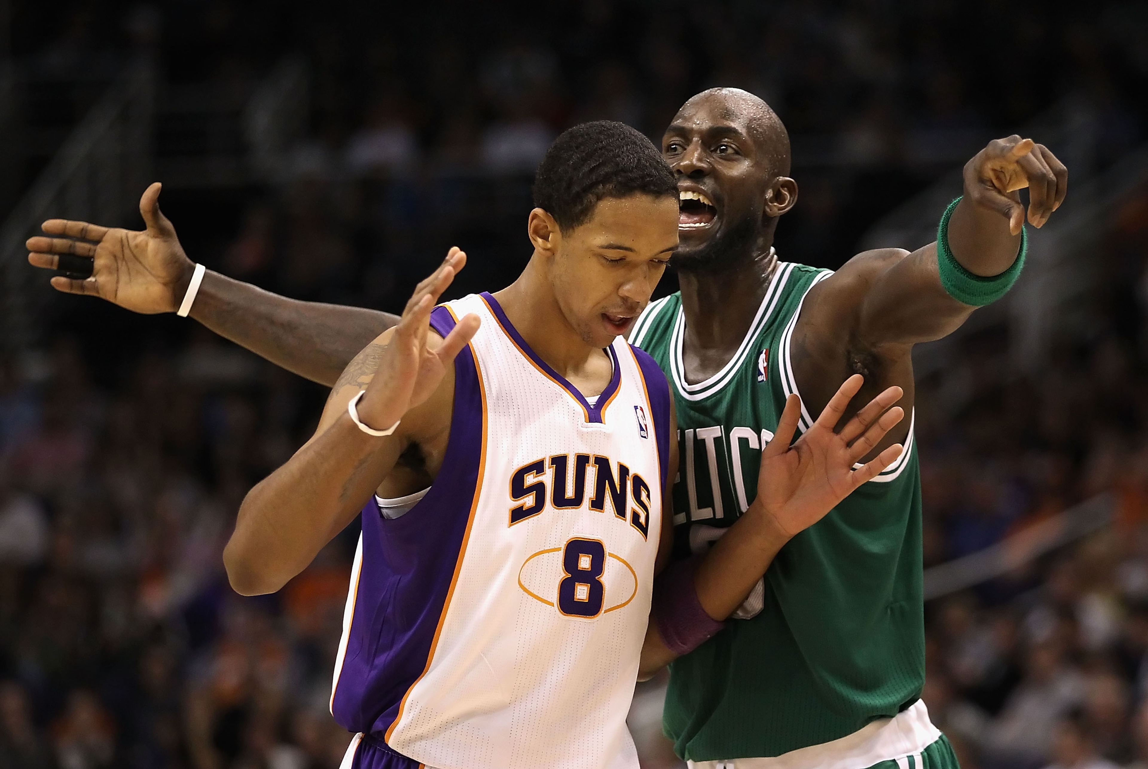 PHOENIX, AZ - JANUARY 28:  Kevin Garnett #5 of the Boston Celtics reacts to Channing Frye #8 of the Phoenix Suns during the NBA game at US Airways Center on January 28, 2011 in Phoenix, Arizona.  The Suns defeated the Celtics 88-71. NOTE TO USER: User exp
