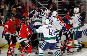CHICAGO - MARCH 05:  A melee breaks out between the Chicago Blackhawks and the Vancouver Canucks in the first minute of play after Andrew Ladd of the Blackhawks and Ryan Kesler of the Canucks start a fight at the United Center on March 5, 2010 in Chicago,