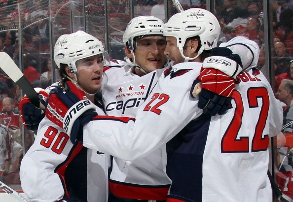 NEWARK, NJ - MARCH 18: (L-R) Marcus Johansson #90, Alex Ovechkin #8 and Mike Knuble #22 of the Washington Capitals celebrate Knubles second goal of the game at 11:24 of the third period against the New Jersey Devils at the Prudential Center on March 18, 2