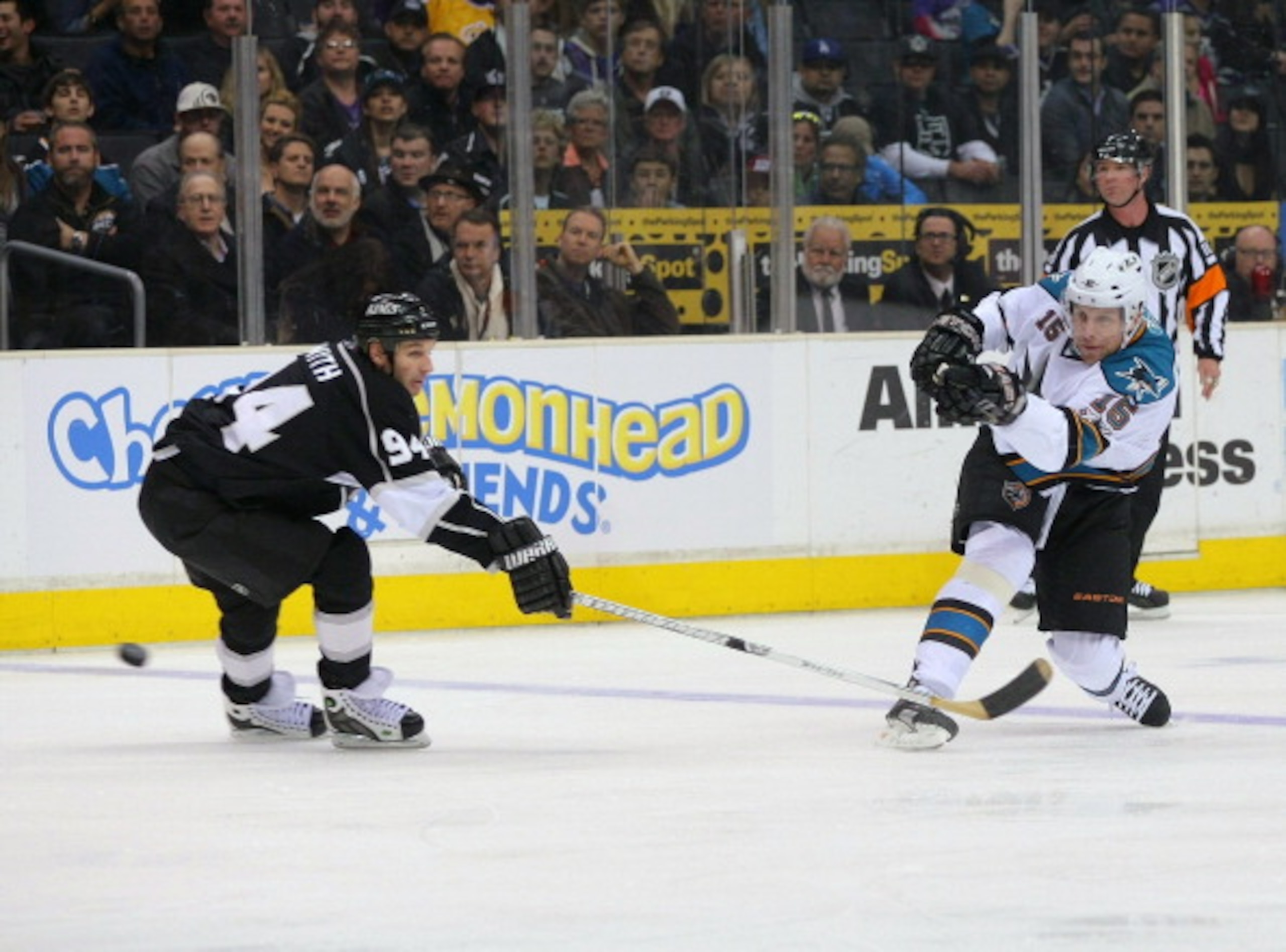 LOS ANGELES, CA - MARCH 24:  Dany Heatley #15 of the San Jose Sharks shoots the puck into the offensive zone  against Ryan Smyth #94 of the Los Angeles Kings in the first period during the NHL game at Staples Center on March 24, 2011 in Los Angeles, Calif