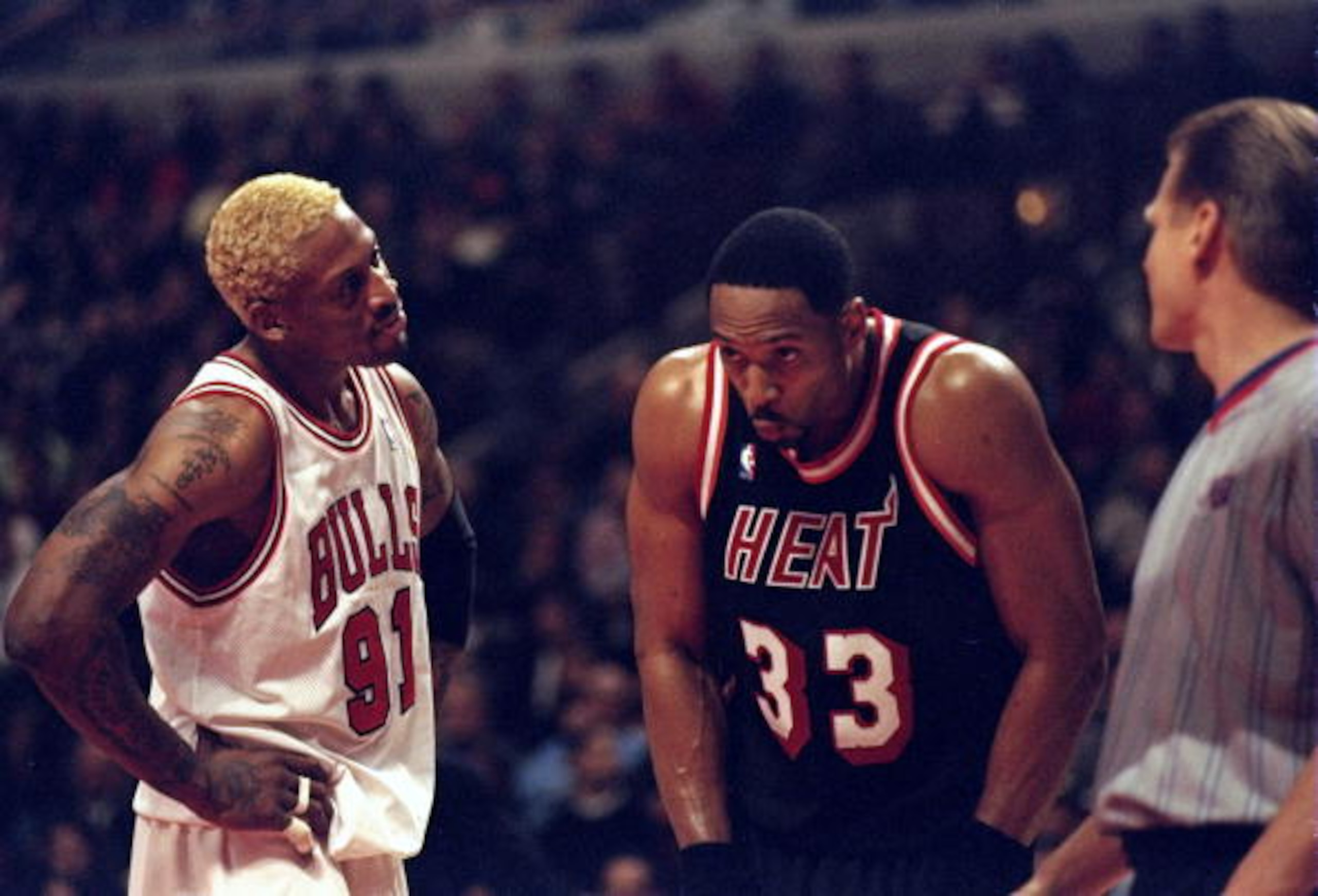 10 Mar 1998:  Center Alonzo Mourning of the Miami Heat (center) stands with forward Dennis Rodman of the Chicago Bulls (left) and referee Steve Javie during a game at the United Center in Chicago, Illinois.  The Bulls defeated the Heat 106-91. Mandatory C