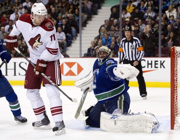 VANCOUVER, CANADA - NOVEMBER 21: Goalie Roberto Luongo #1 of the Vancouver Canucks makes a glove save while Martin Hanzal #11of the Phoenix Coyotes tries to provide a screen during the first period in NHL action on November 21, 2010 at Rogers Arena in Van