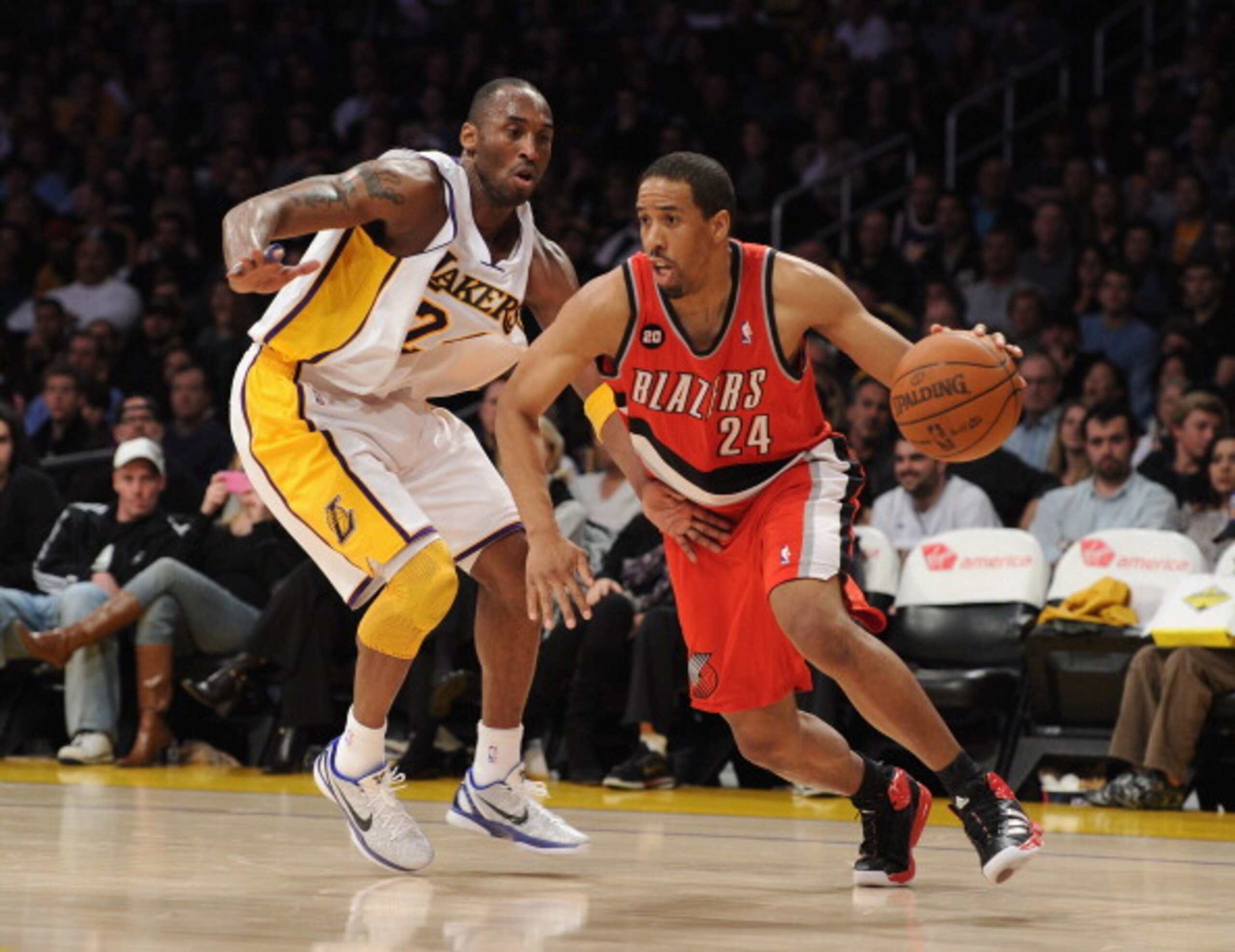 LOS ANGELES, CA - MARCH 20:  Andre Miller #24 of the Portland Trail Blazers dribbles around Kobe Bryant #24 of the Los Angeles Lakers at the Staples Center on March 20, 2011 in Los Angeles, California.  NOTE TO USER: User expressly acknowledges and agrees