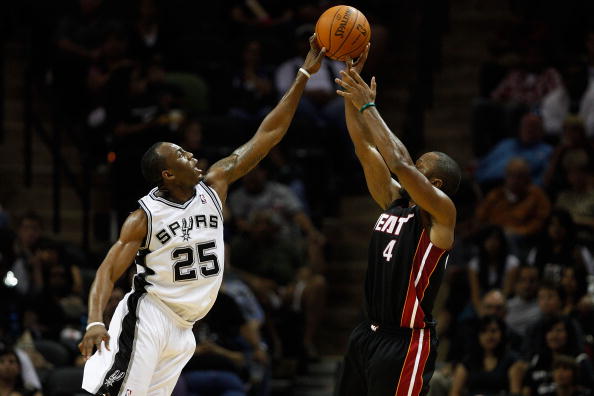 SAN ANTONIO - OCTOBER 09:  Kenny Hasbrouck #4 of the Miami Heat has a shot blocked by James Anderson #25 of the San Antonio Spurs at the AT&T Center on October 9, 2010 in San Antonio, Texas.  NOTE TO USER: User expressly acknowledges and agrees that, by d