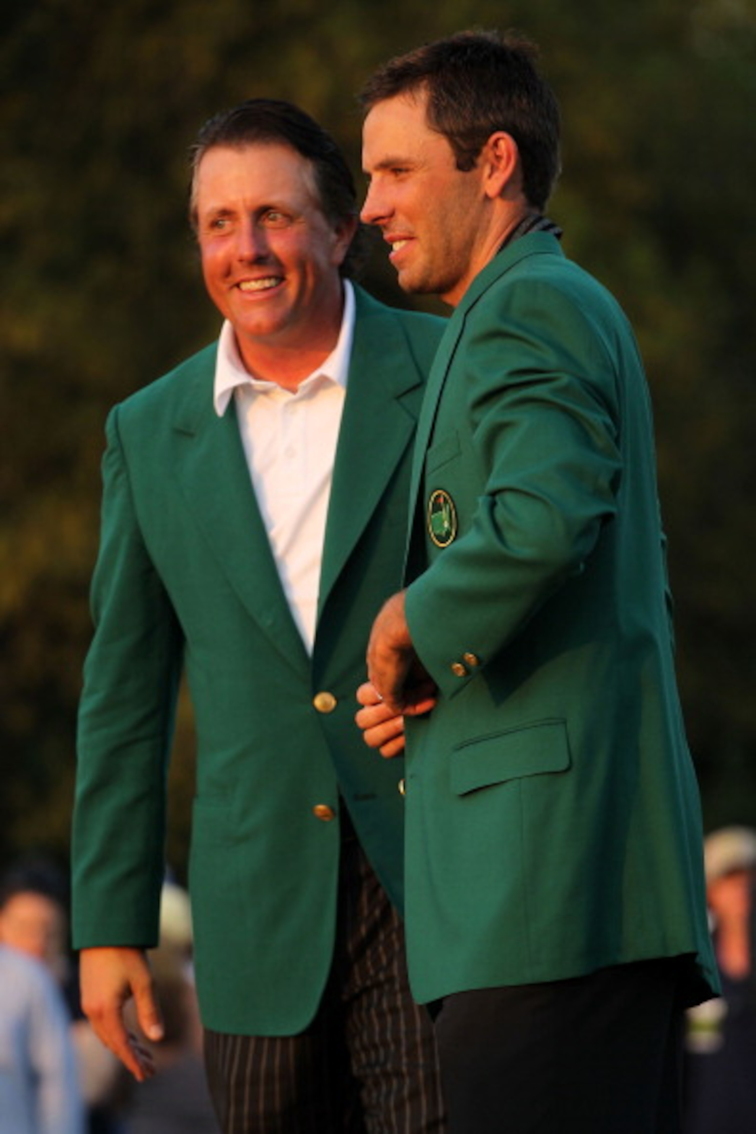 AUGUSTA, GA - APRIL 10:  Phil Mickelson presents Charl Schwartzel of South Africa the winner's jacket at the green jacket presentation after Schwartzel's two-stroke victory at the 2011 Masters Tournament at Augusta National Golf Club on April 10, 2011 in 