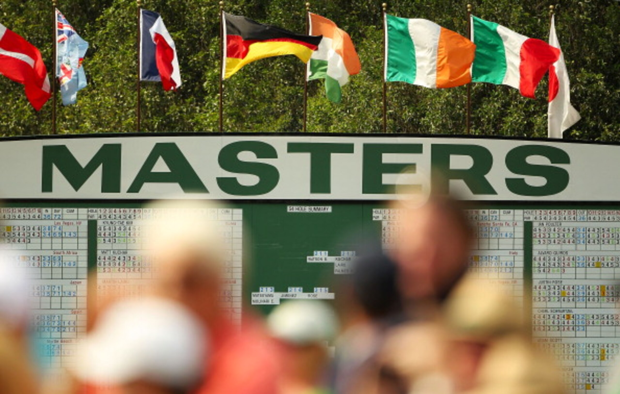 AUGUSTA, GA - APRIL 09:  Patrons are seen watching the play near a leaderboard during the third round of the 2011 Masters Tournament at Augusta National Golf Club on April 9, 2011 in Augusta, Georgia.  (Photo by Jamie Squire/Getty Images)