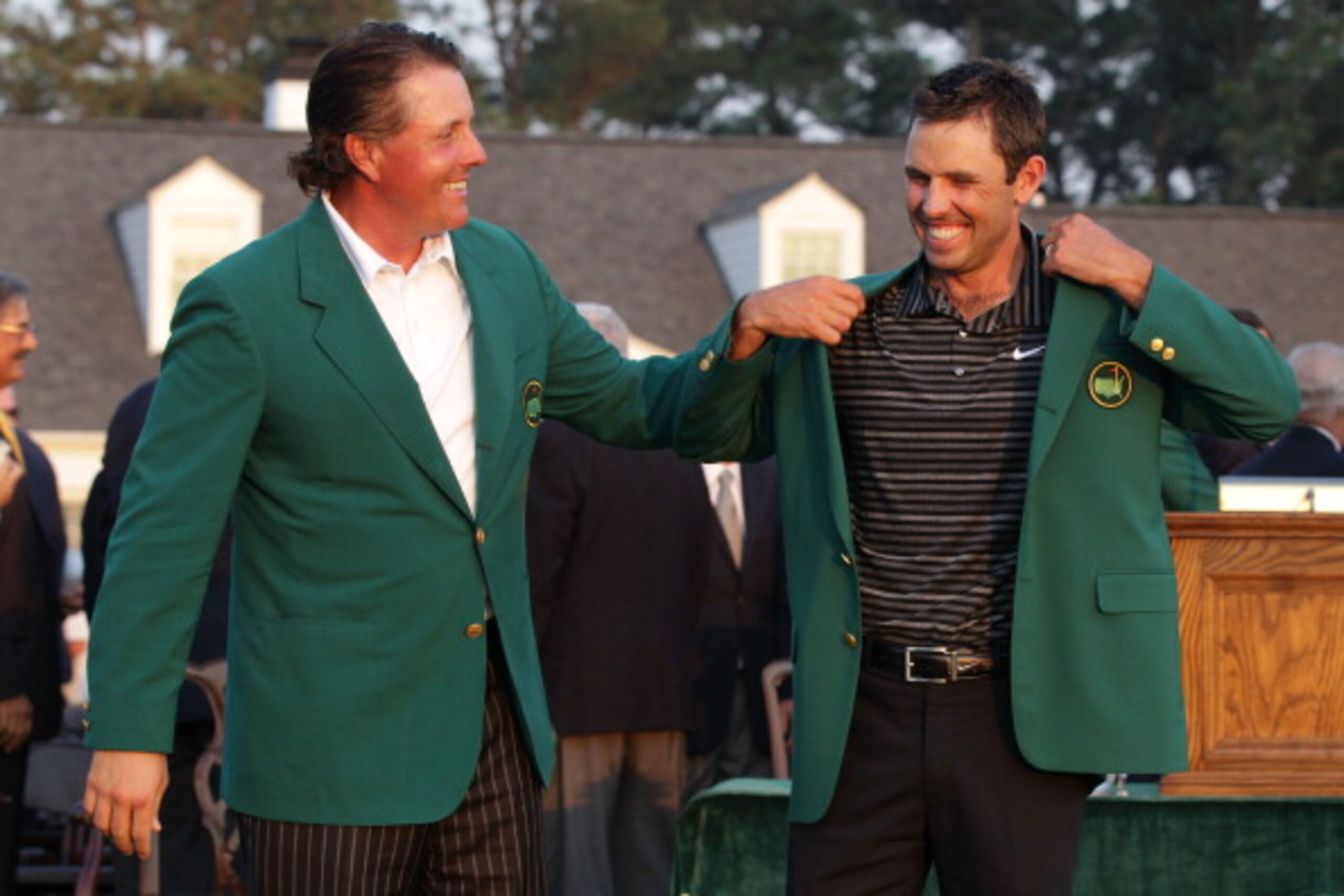 AUGUSTA, GA - APRIL 10:  Phil Mickelson presents Charl Schwartzel of South Africa the winner's jacket at the green jacket presentation after Schwartzel's two-stroke victory at the 2011 Masters Tournament at Augusta National Golf Club on April 10, 2011 in 