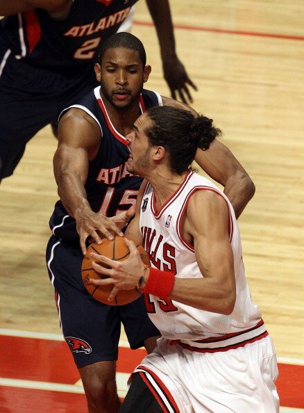 CHICAGO, IL - MARCH 11: Joakim Noah #13 of the Chicago Bulls drives against Al Horford #15 of the Atlanta Hawks at the United Center on March 11, 2011 in Chicago, Illinois. The Bulls defeated the Hawks 94-76. NOTE TO USER: User expressly acknowledges and