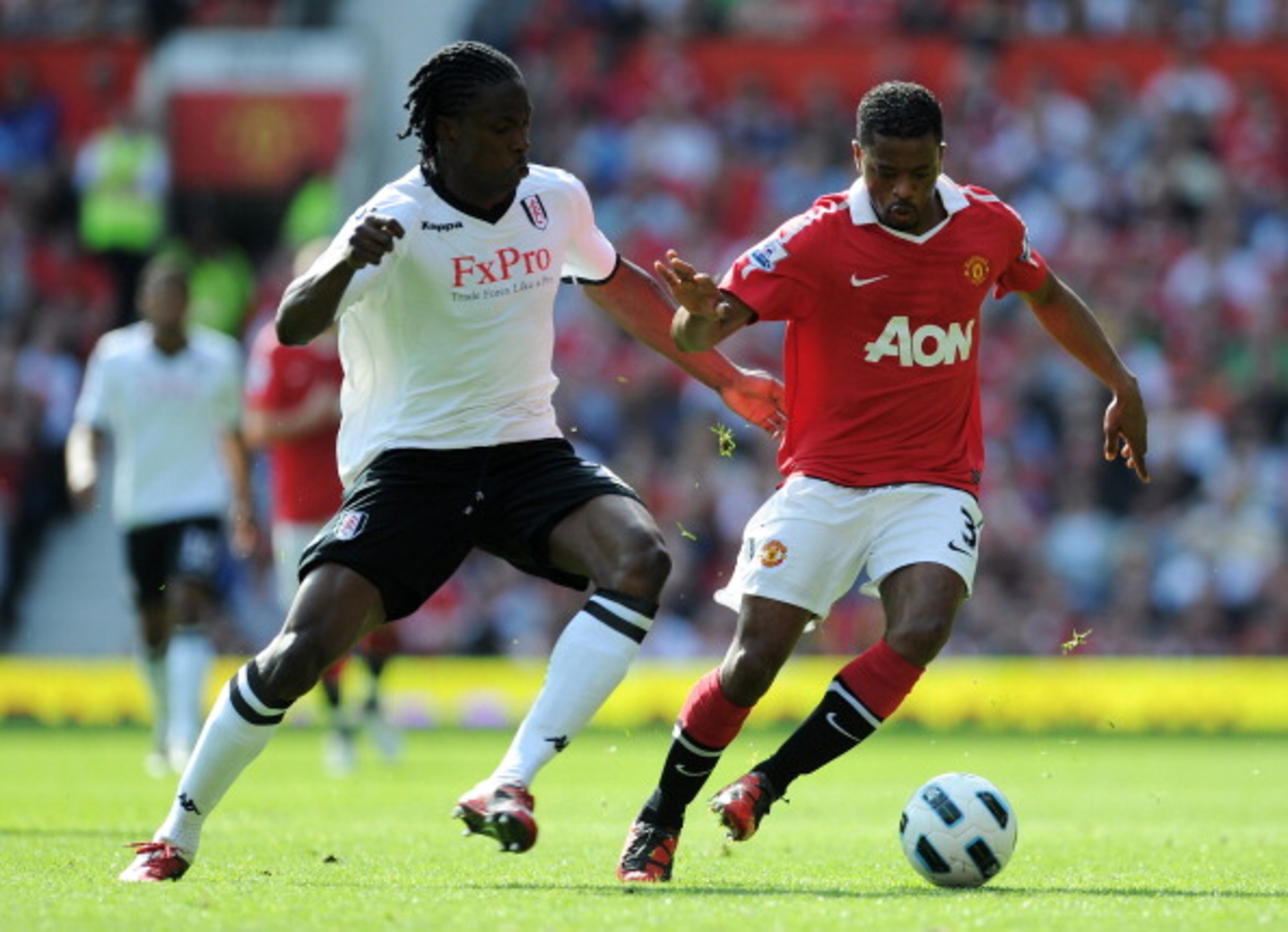 MANCHESTER, ENGLAND - APRIL 09: Patrice Evra of Manchester United is closed down by Dickson Etuhu of Fulham during the Barclays Premier League match between Manchester United and Fulham at Old Trafford on April 9, 2011 in Manchester, England. (Photo by MANCHESTER, ENGLAND - APRIL 09: Patrice Evra of Manchester United is closed down by Dickson Etuhu of Fulham during the Barclays Premier League match between Manchester United and Fulham at Old Trafford on April 9, 2011 in Manchester, England. (Photo by