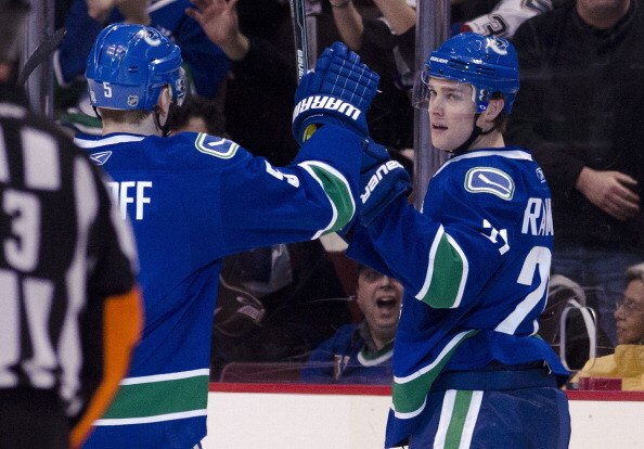 VANCOUVER, CANADA - APRIL 7: Mason Raymond #21of the Vancouver Canucks in congratulated by Christian Ehrhoff #5 after scoring against the Minnesota Wild during the first period in NHL action on April 07, 2011 at Rogers Arena in Vancouver, BC, Canada.  (Ph