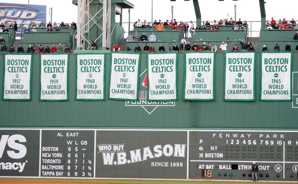 BOSTON - APRIL 20:  Boston Celtic Championship banners hung from the Green Monster during a tribute to Red before the start of the Boston Red Sox  versus the New York Yankees on April 20, 2007 at Fenway Park in Boston, Massachusetts.  (Photo by Elsa/Getty