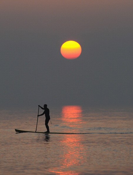 BRIGHTON, ENGLAND - MARCH 21:  A paddle boarder in action at sunset on Brighton Beach on March 21, 2011 in Brighton, England.  (Photo by Mike Hewitt/Getty Images)