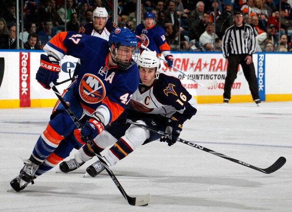 UNIONDALE, NY - MARCH 24:  Andrew Ladd #16 of the Atlanta Thrashers skates after Andrew MacDonald #47 of the New York Islanders during an NHL hockey game at the Nassau Coliseum on March 24, 2011 in Uniondale, New York.  (Photo by Paul Bereswill/Getty Imag